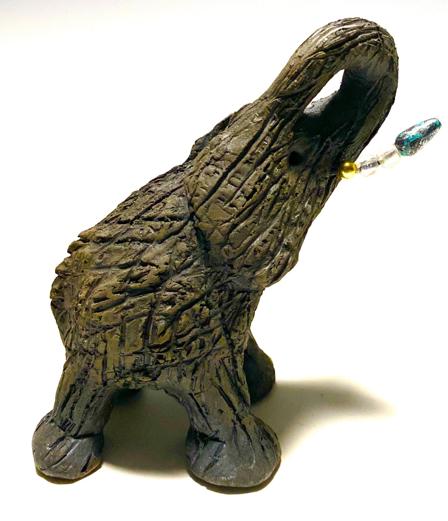 Elephants are one of my favorite animals to create. They are so majestic" Just one of these lovely Raku Fired Elephant will make an excellent gift for your BFF, or just for you . This raku fired elephant stands 7" x 2" x 2.5" and weighs 7 ounces. She has beaded tusks and a textured charcoal body. Nice!