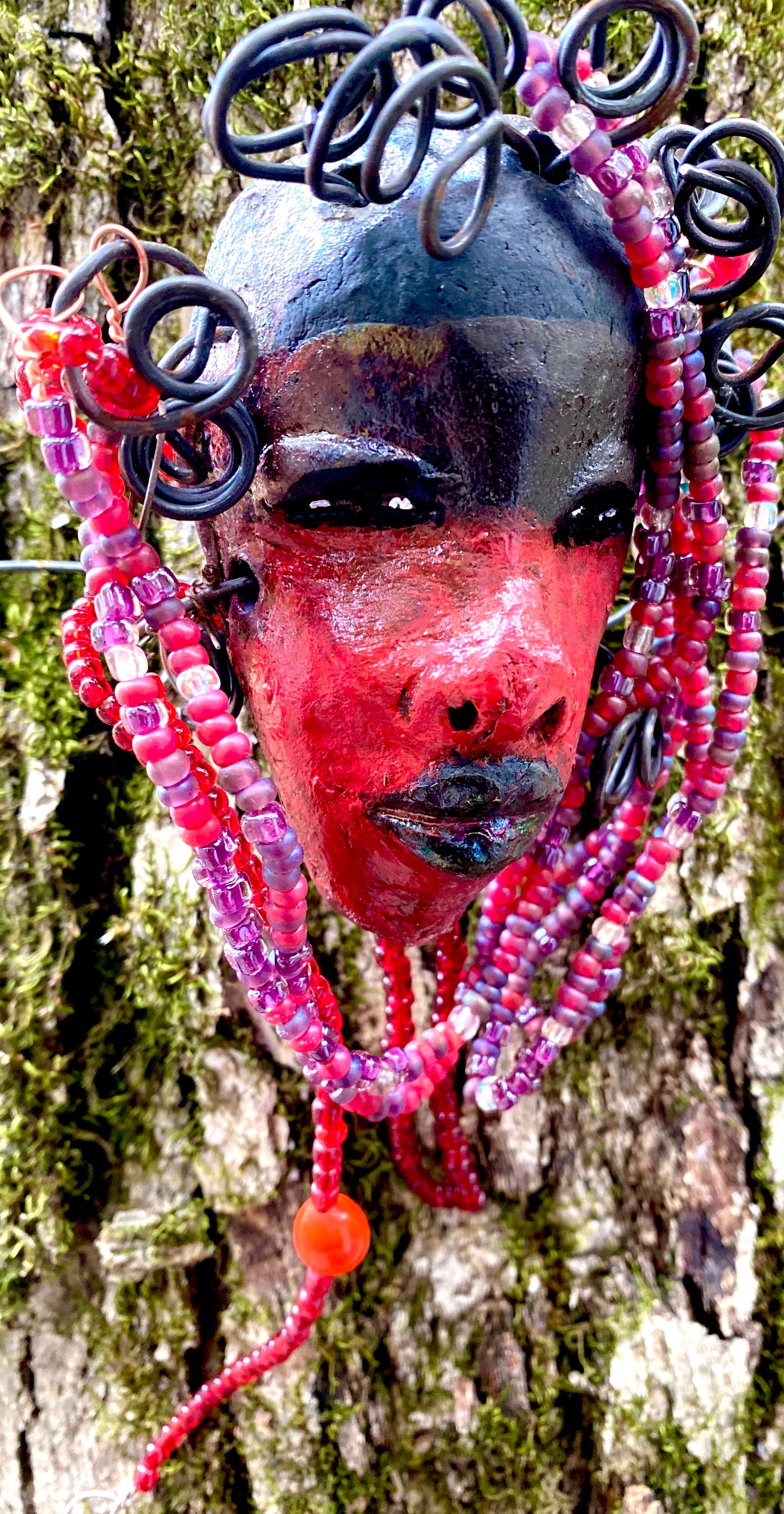Meet Hariel! I started making art soon after seeing authentic African artwork at the Smithsonian Museum of African Art. I was in total awe. Jafari was inspired by my visit there. Hariel has a two tone red and dark metallic copper complexion. She is 6" x 4" and weighs 5 ozs. Hariel has over 4 feet of coiled 16 gauge wire hair and countless red mini beads..