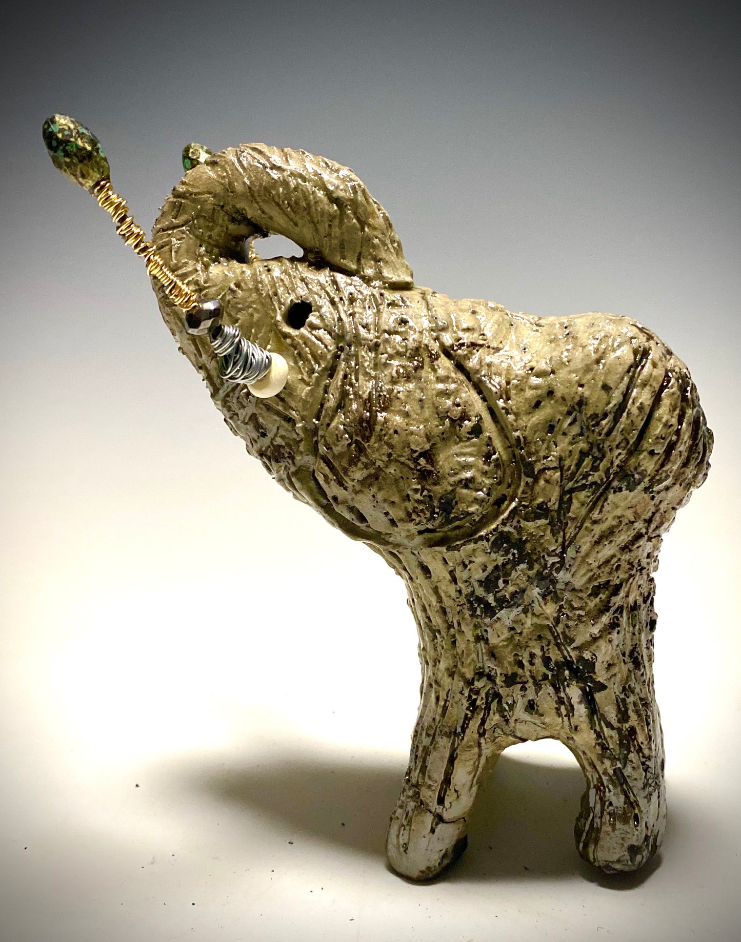 Raku Elephant Have you HERD!!!!!! Just one of these lovely Raku Fired Elephant will make an excellent gift for your friend, sorority or for your home’ special place centerpiece. 6" x 3" x 4" 1.3 lbs Beautiful metallic white raku elephant For decorative purposely only