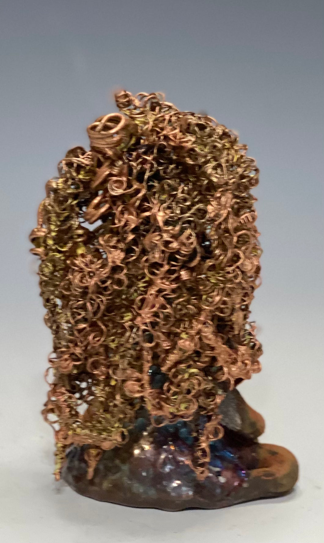 Meet Tiana! Tiana stands 5" x 3.5" x 3.5" and weighs 10 ozs. She has a lovely honey brown complexion. Tiana's dress is metallic copper. She has her long loving arms resting at her side. " I am really pleased with Tiana's blue beaded necklace and her new wire hair Find a place in your space for Tiana!