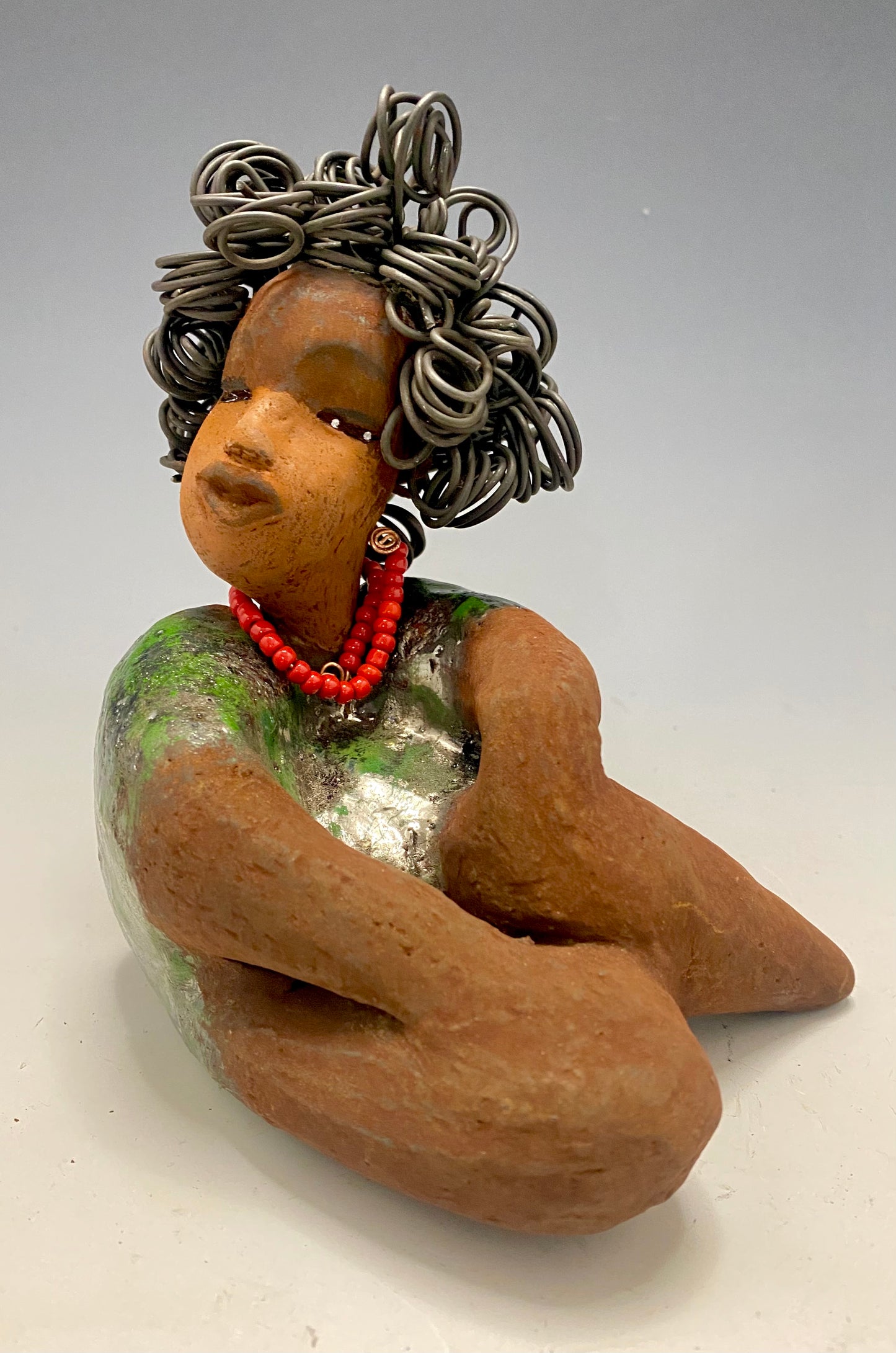 Meet Patricia! Patricia is approx. 6"x 4" x 5" and weighs approx. 1.5 pounds. Her long loving arms rest at her lap. Patricia has a lovely honey rust colored complexion. Yes she is a Big Girl! Patricia's dress is glossy green with large gold patterned dots . A string of ruby red beads wraps snugly around her neck. Patricia's hair is made of curly 16 gauge wire. Free Shipping! Got Questions???? Instant Message or Chat with me. Shipping and Returns