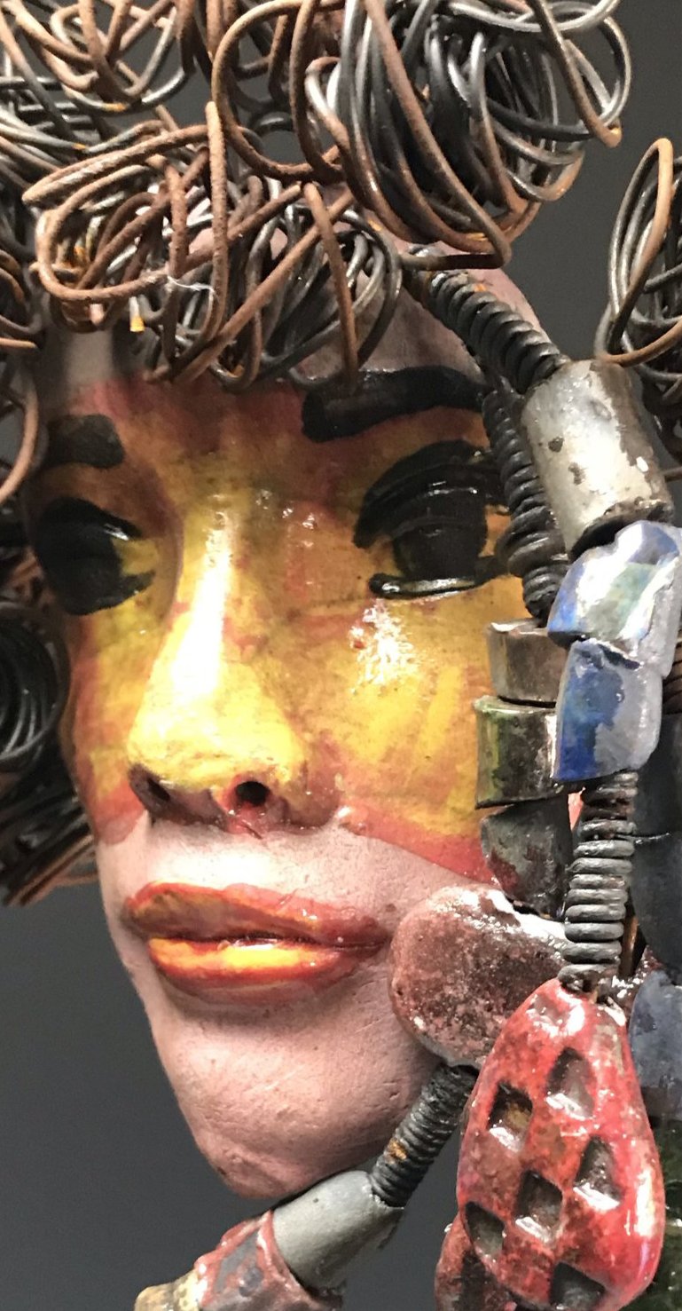 Meet Quisha! I started making mask after seeing an authentic African Mask collection at the Smithsonian Museum of African Art. I was in total awe. Quisha was inspired by my visit there. Quisha has a complexion of mustard and honey brown. She is 7" x 12" and weighs 1.3 lbs. Quisha has over 40 handmade raku fired beads. She has over 20 feet of coiled 16 gauge wire hair. Quisha won't be around long at Half Priced!