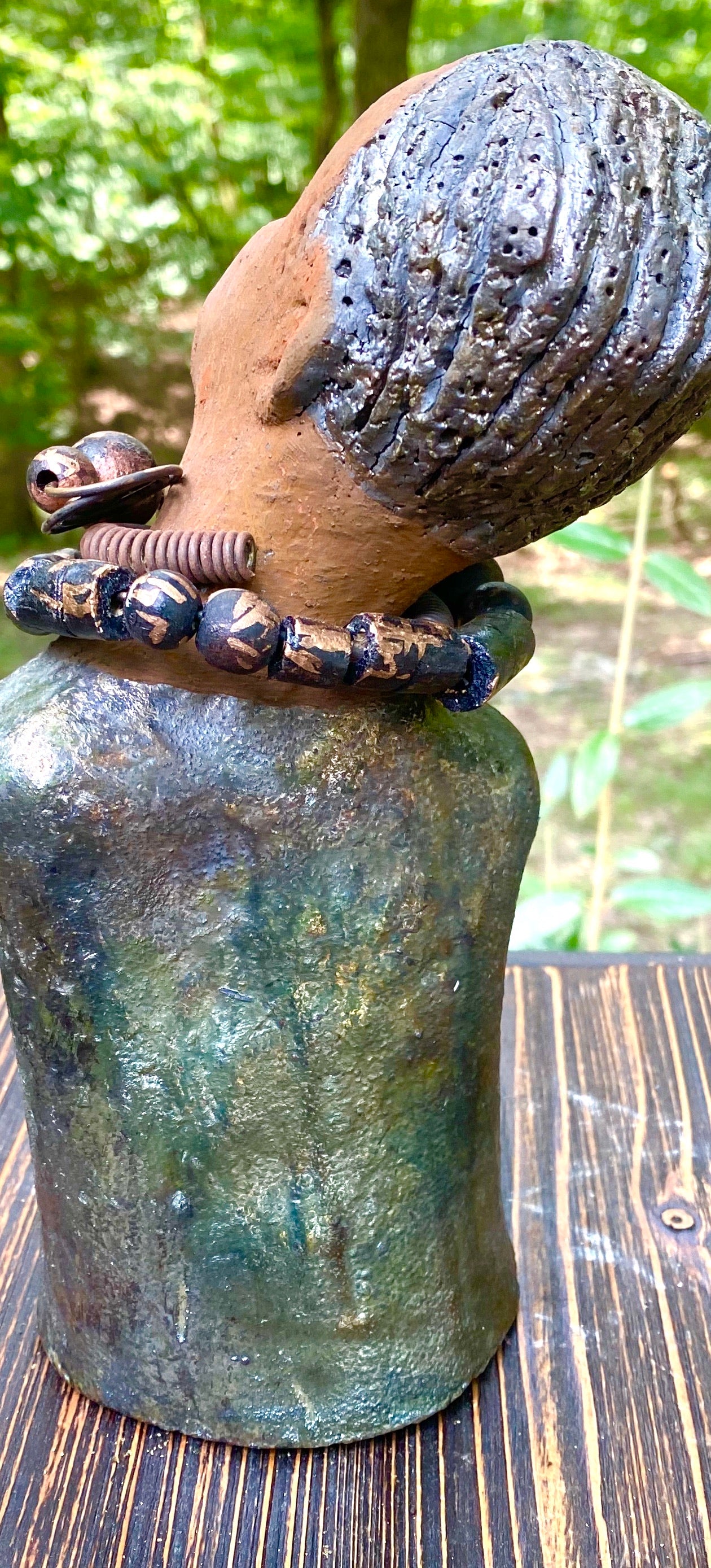 "It is obvious Herdew implies that most of my sculptures are female. My goal this year is to create ten male sculptures. Alvin is one of the first that I am pleased with. Alvin stands 9" x 4" x 4" and weighs 2.13 lbs. He wears a metallic multi colored jacket with metallic beads. Alvin has a dark honey brown complexion. Alvin seems to be in deep thought. Alvin would display proudly in your home.