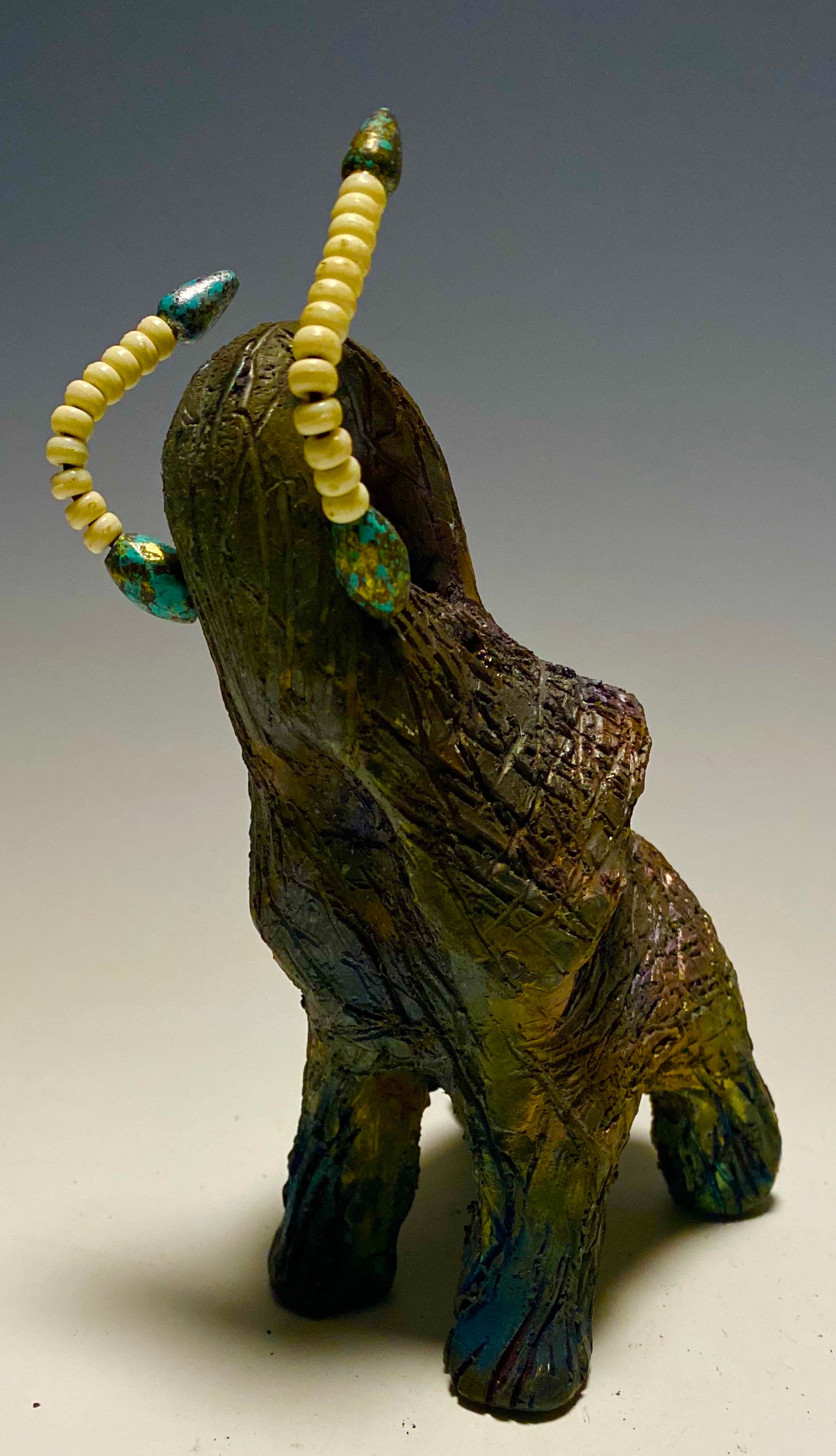 Have you HERD!!!!!! Elephants are one of my favorite animals to create. They are so majestic" Just one of these lovely Raku Fired Elephant will make an excellent gift for your BFF, or just for you . This raku fired elephant stands 6" x 4" x 5" and weighs 1 lb. She has beaded tusks and a textured charcoal and copper metallic body. This one is nice to add your Herdew Collection!