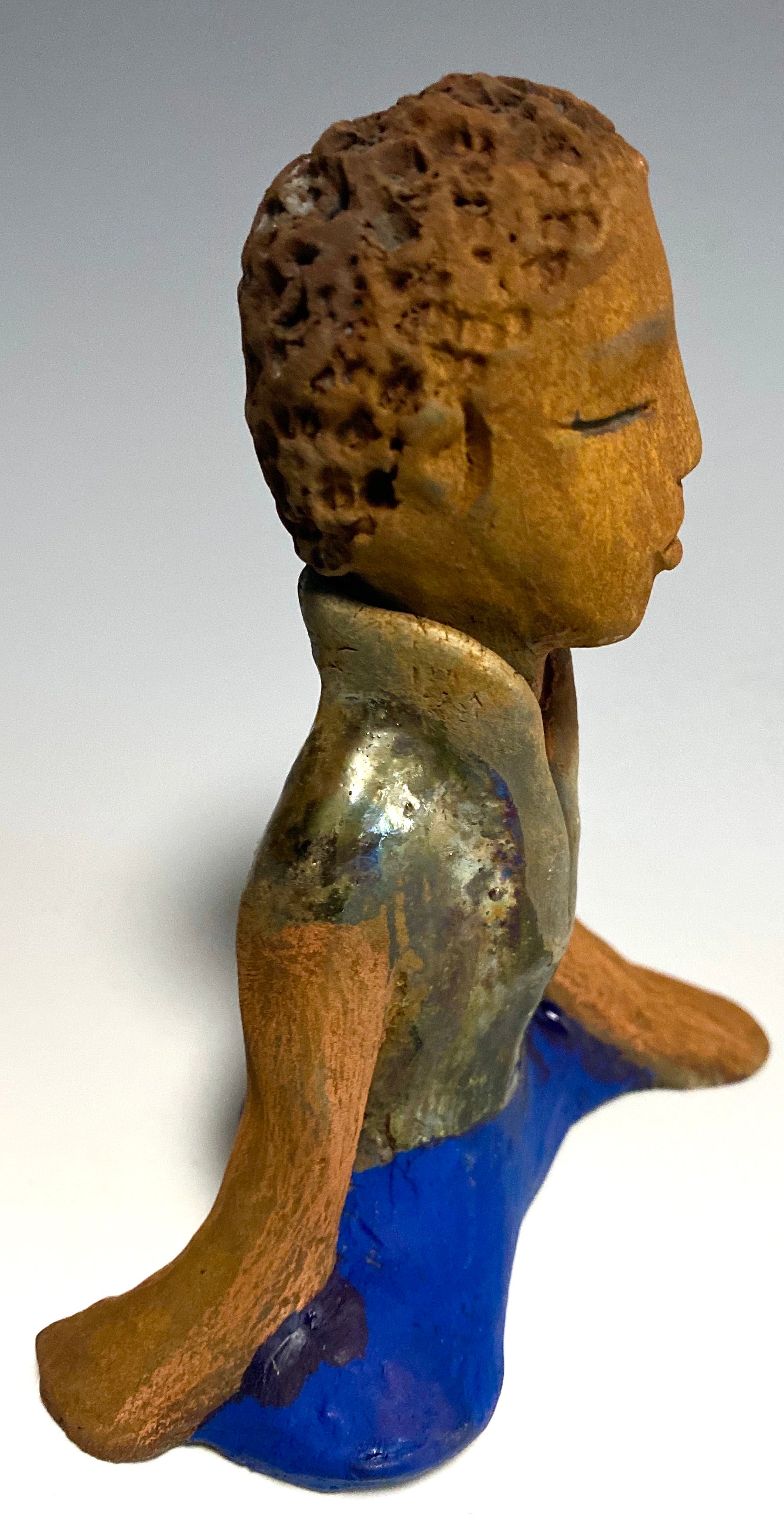 Travis is one teen who does respect his elders.   Travis stands  5" x 4" x 3" and weighs 9 ozs. He wears a metallic green shirt with blue jeans . Travis complexion is honey brown. He is thoughtful with a gentle spirit His  arms rest at his knees as he waits on you.