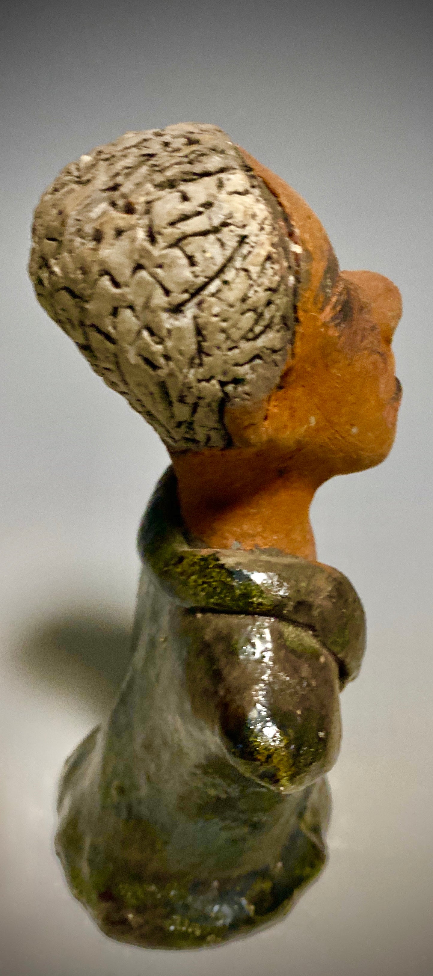 Mr. Charles has a story to tell! Do you See the wisdom in his face? Mr. Charles stands 5"x 3" x 2.5" and weighs 11 ozs. He wears a copper green metallic jacket. Mr. Charles's complexion is honey brown and he has salt and pepper hair.