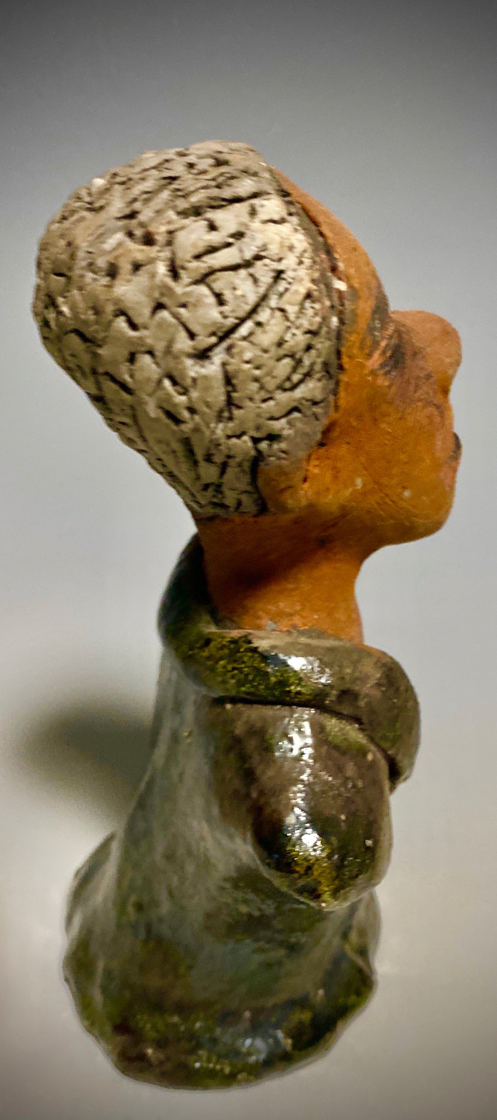 Mr. Charles has a story to tell!  Do you See the wisdom in his face? Mr. Charles  stands 5"x 3" x 2.5" and weighs 11 ozs. He wears a copper green metallic jacket. Mr. Charles's complexion is honey brown and he has salt and pepper hair.