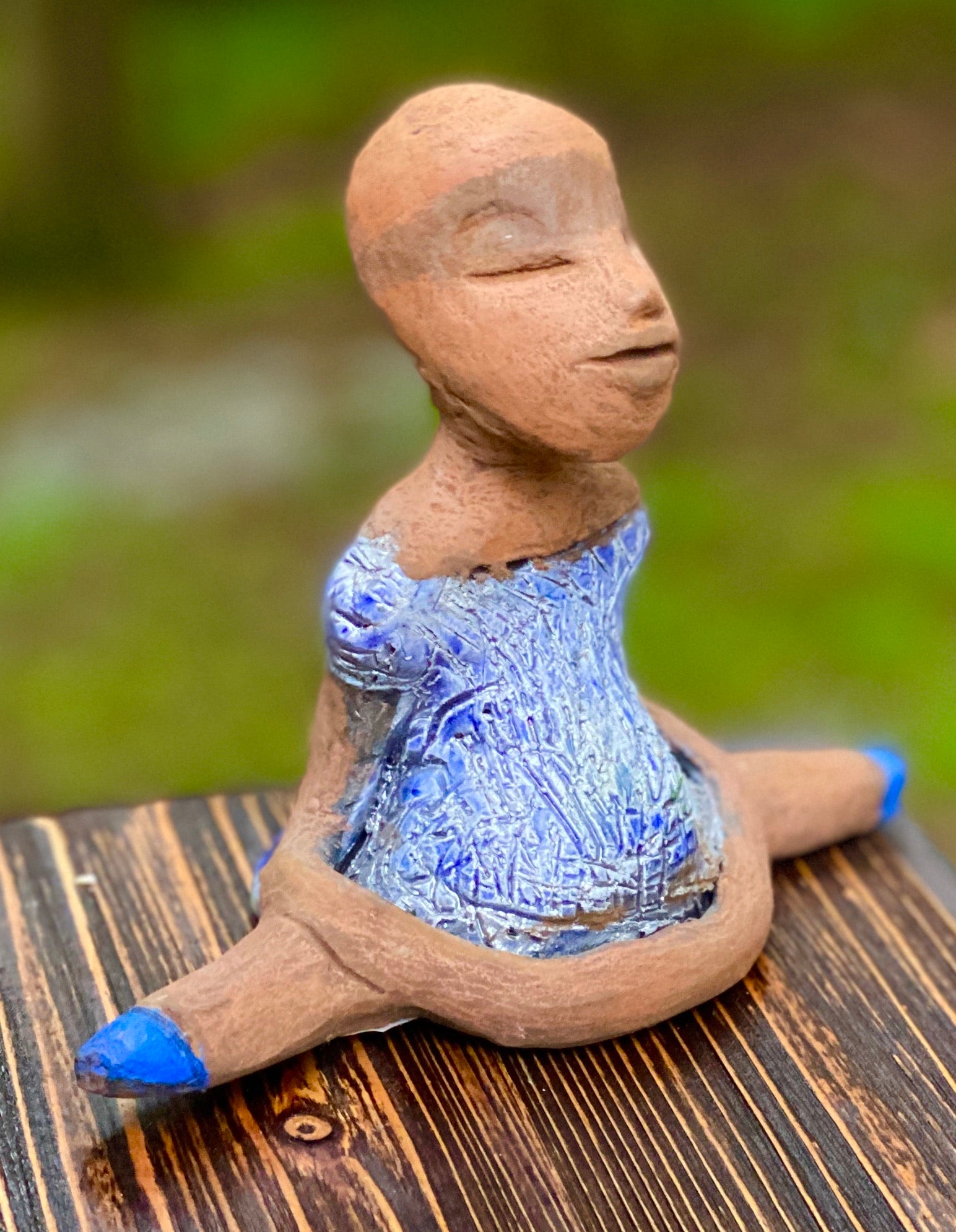 Bailey is a Mermaid! Bailey stands 5" x 4" x 5" and weighs 10 ozs. Yes Bailey is a mermaid! She has a honey brown complexion with clay hair. She has a copper metallic swimsuit. Bailey has her long loving arms folded as she rest and waits.  Give Bailey the Mermaid a special place inside of your home.