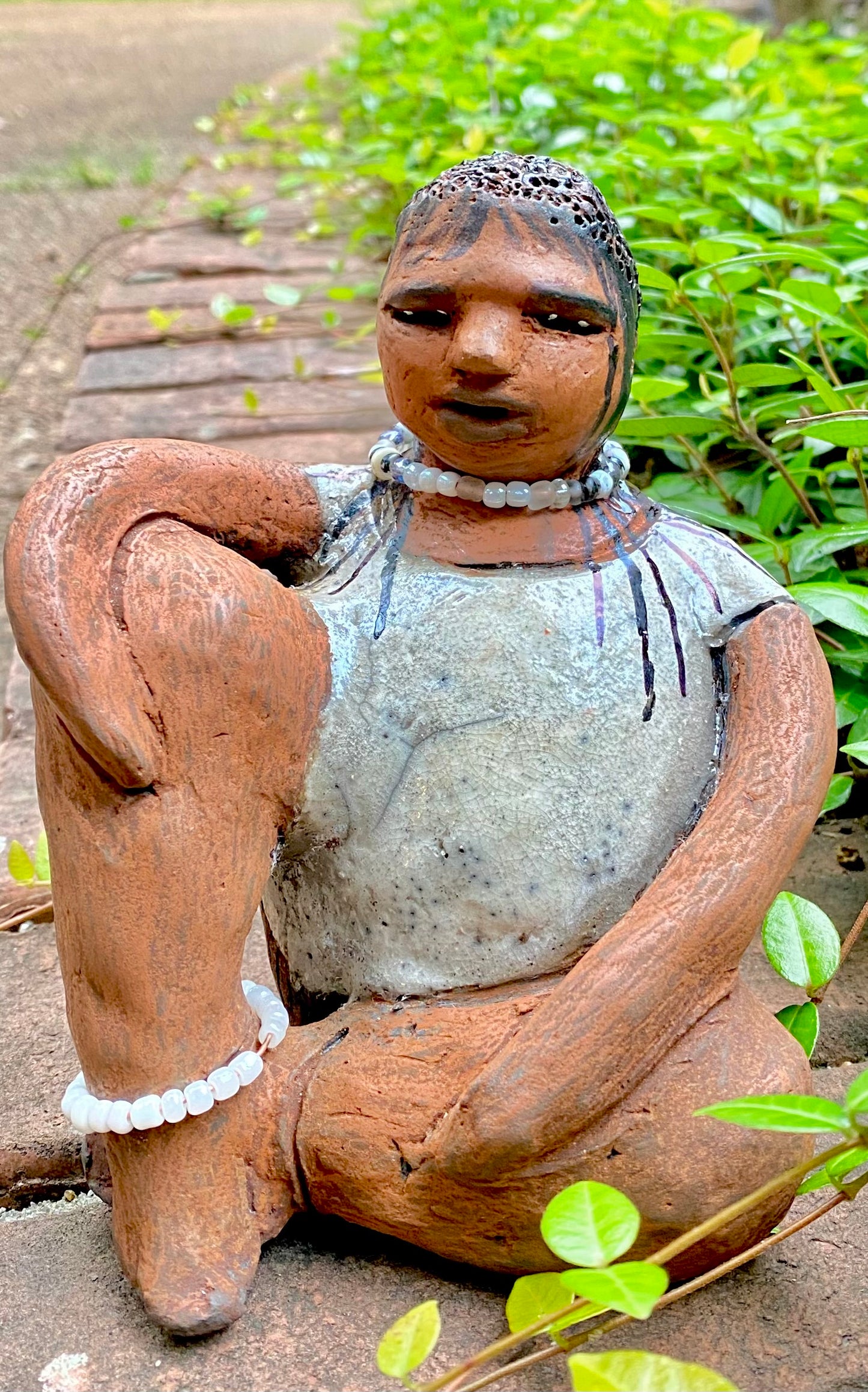Meet Shelia ! You will fall in love with Shelia! Yes she is a big girl with lots of charm! Her long loving arms are relaxed atop her legs. Shelia has a lovely honey rust colored complexion. Shelia sits 6" x 5" x 4" and weighs 1.5 lbs. Shelia 's dress is a warm matte white crackle. Shelia’s hair is made of clay with many fine draw in braids. Check out our Shipping and Return policy Free Shipping! Got Questions???? Instant Message or Chat with me.