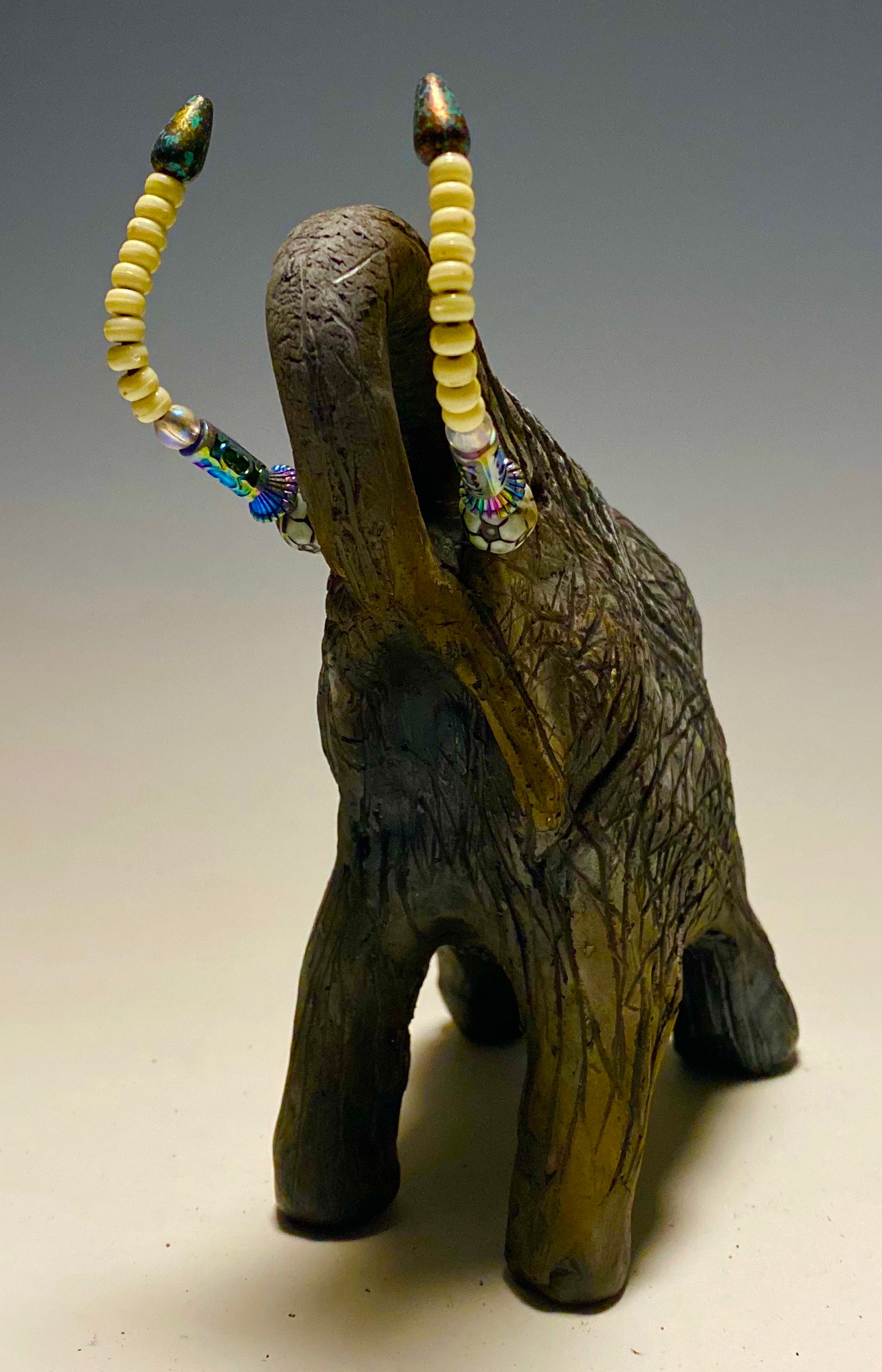 Raku Elephant Have you HERD!!!!!! Just one of these lovely Raku Fired Elephant will make an excellent gift for your friend, sorority or for your home’ special place centerpiece. 7" x 4" x 4" 1.7 lbs Beautiful metallic matte raku elephant For decorative purposely only