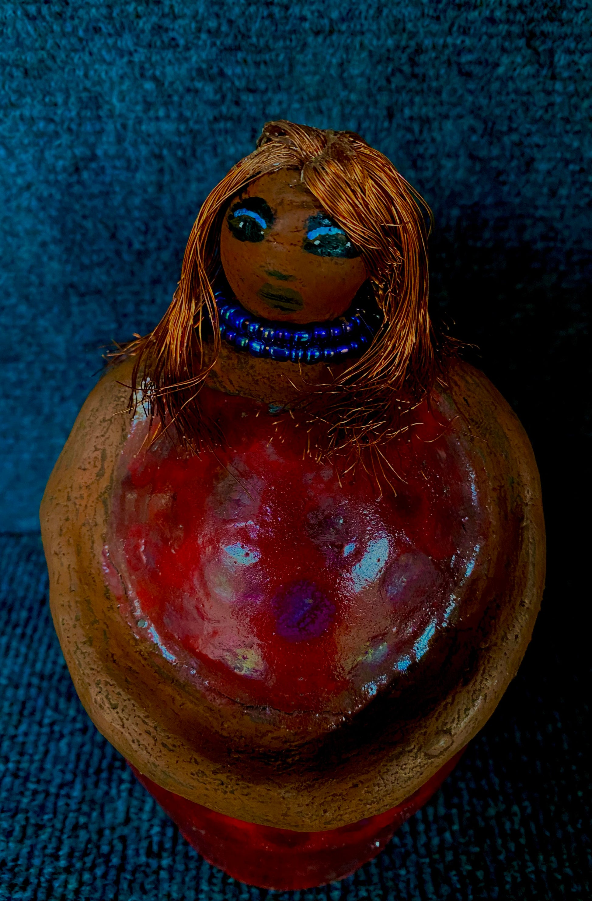 Meet Dora!  She is a big girl who loves to sing and has aspirations of becoming a  movie star.  Dora stands 7" x 4" x 4.5" and weighs  1.06 lbs.  She has a lovely honey brown complexion with lovely reddish brown lips.  Dora has a lovely gold spotted heart glazed dress.  She wears a beaded  dark blue necklace.  With eyes wide opened, Dora has hopes of finding a new home.   Dora has a twin sister name Cora.