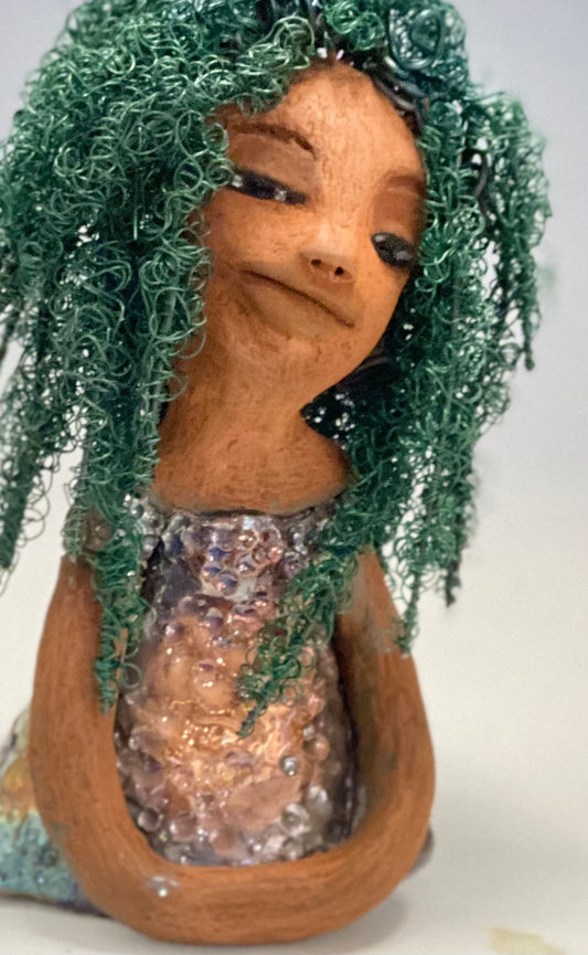 Nia Nia stands 8" x 5" x 5.5" and weighs 1.04 lbs. She has a lovely honey brown complexion with soft brown lips. She has long twisted wire locs hairstyle waist down!  Nia has a glossy metallic copper glazed dress. She has over 75 feet of 16 and 24 gauge emerald green wire for hair. It really took over 6 hours just to twist and do her hair! With  eyes wide opened, Alexis has hope of finding a new home.