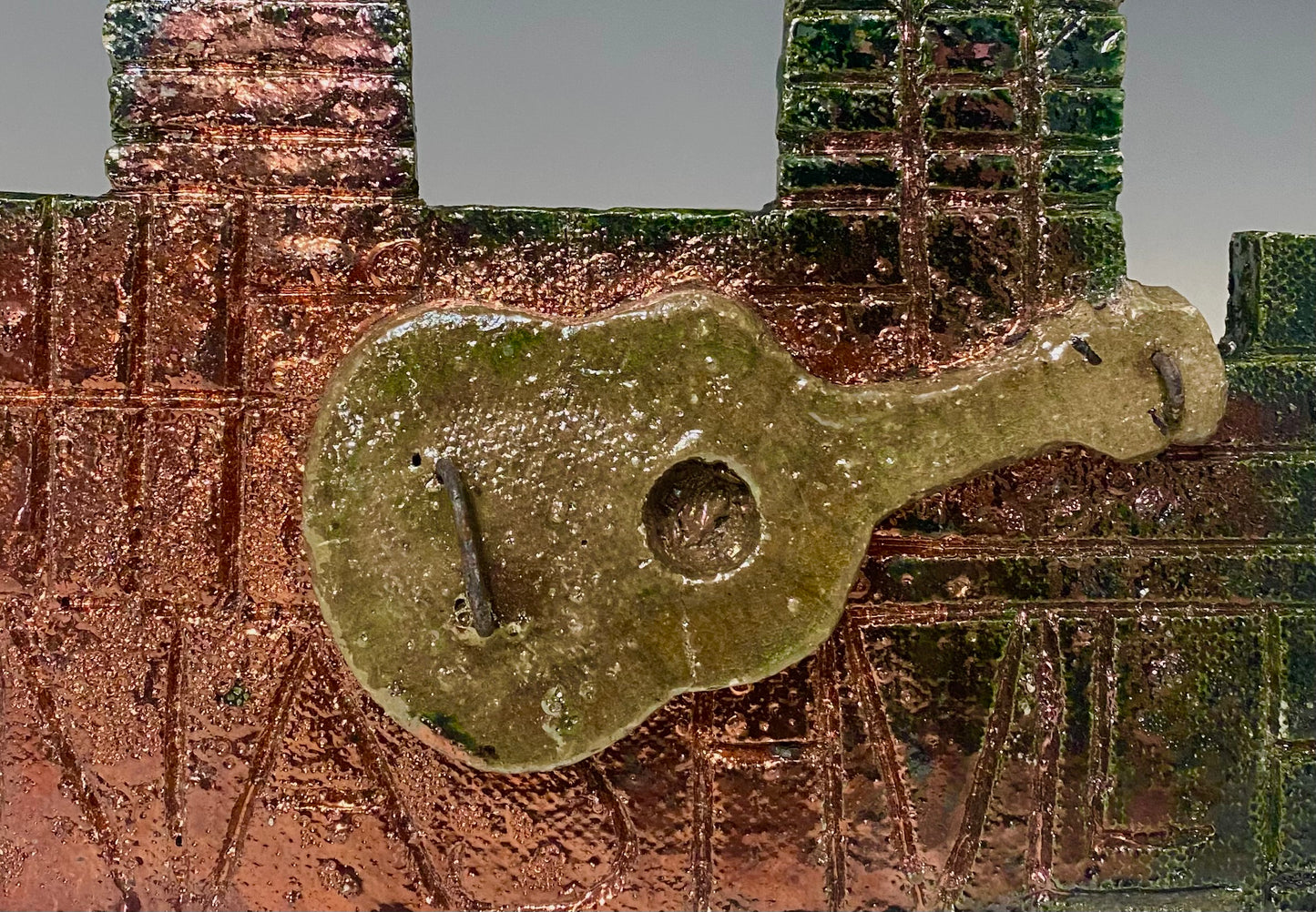Skyline of Downtown Nashville with country guitar! 4.5” x 5.5” (irregular cut ) 7.45 ozs Metallic copper glaze etched back hook