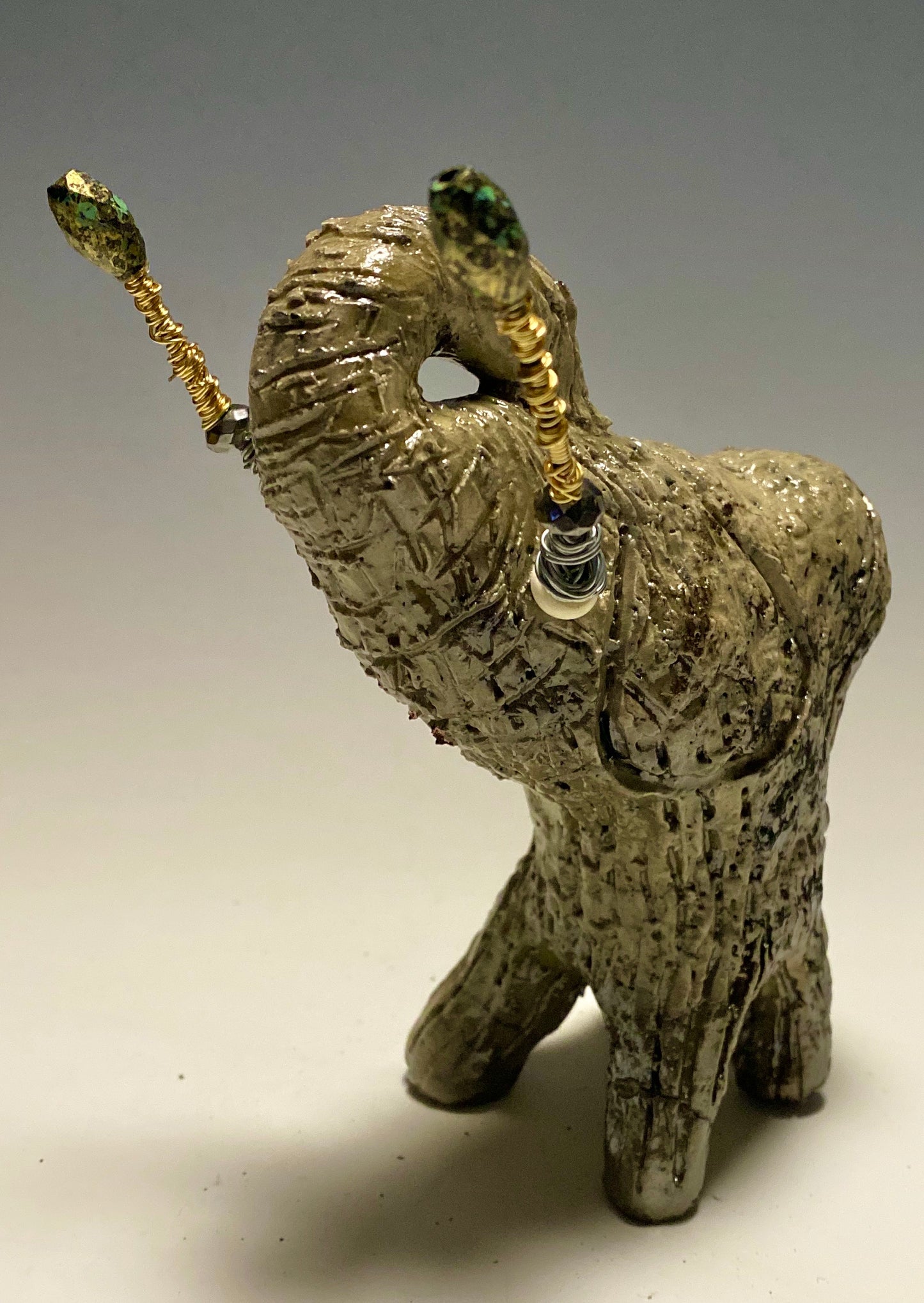 Raku Elephant Have you HERD!!!!!! Just one of these lovely Raku Fired Elephant will make an excellent gift for your friend, sorority or for your home’ special place centerpiece. 6" x 3" x 4" 1.3 lbs Beautiful metallic white raku elephant For decorative purposely only