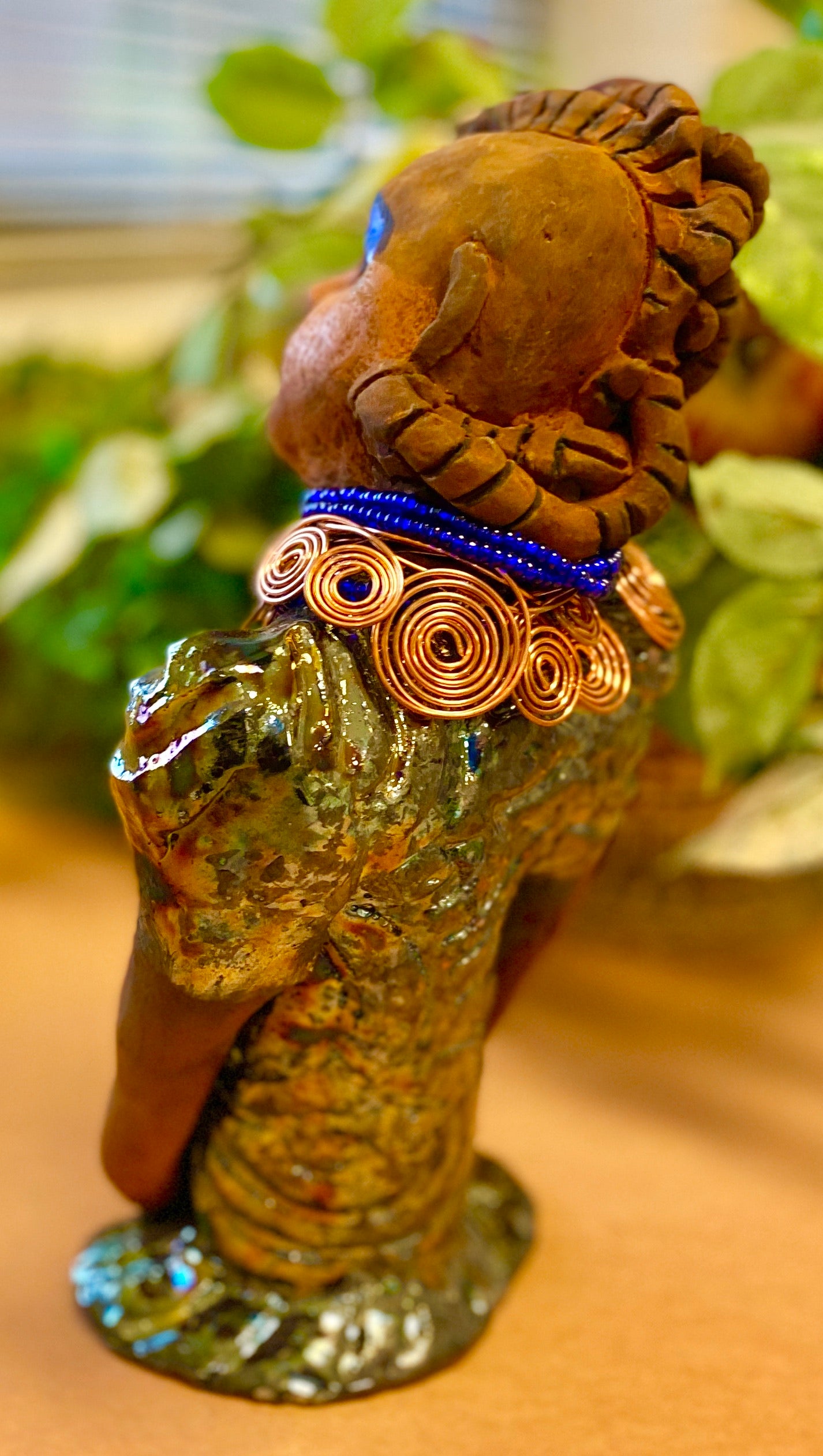 Georgia stands 11" x 5" x 3" and weighs 2.15 lbs. She has a honey brown complexion with a braided tribal clay hairstyle. She has an awesome copper metallic glitzy dress. Georgia has her long loving arms folded as she rest and waits. Give Georgia special place inside of your home.