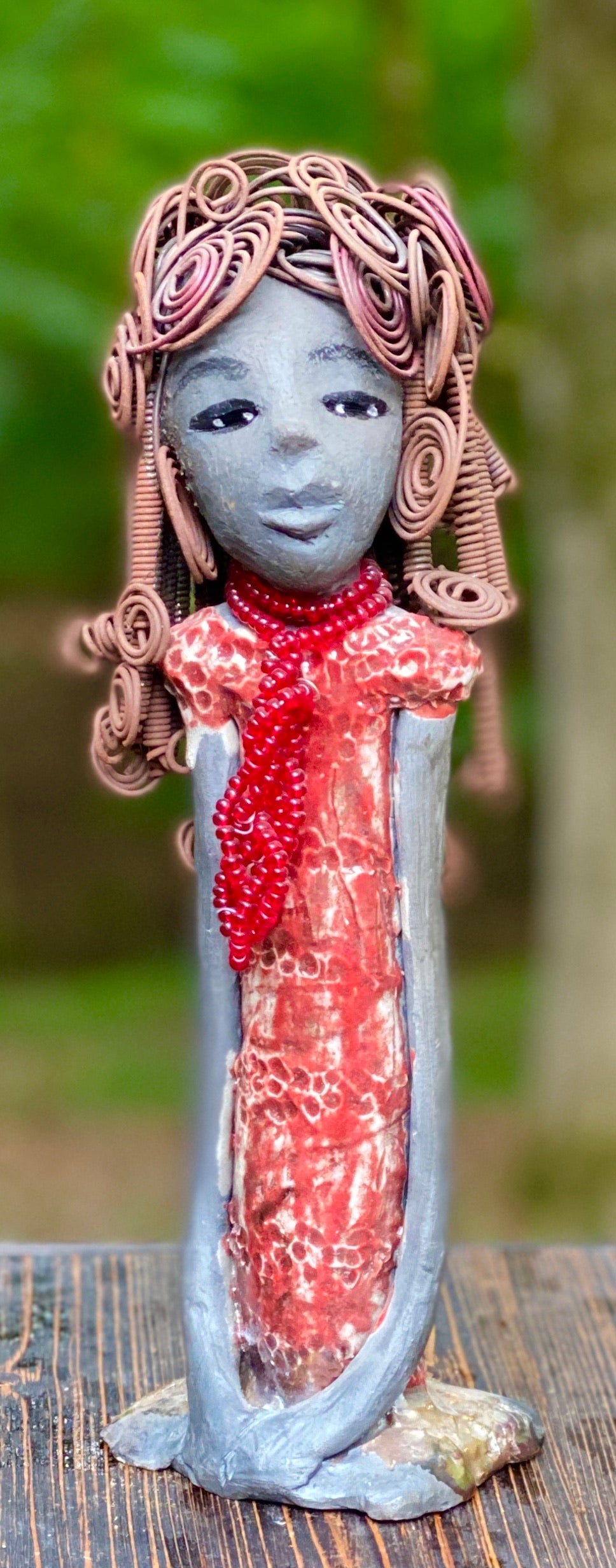 Meet Reagan! Reagan stands 12" x 4" x 4" and weighs 2.10 lbs. Reagan has a lovely dark complexion. It took over two hours to fix her Herdew! It is made of 16 gauge wire. Reagan has a shimmering metallic copper red dress. A strand of ruby red beads hangs around her neck. Reagan and her sister Carolyn are one of a kind. ( Sold Separately) Give Reagan and Carolyn a great Home!