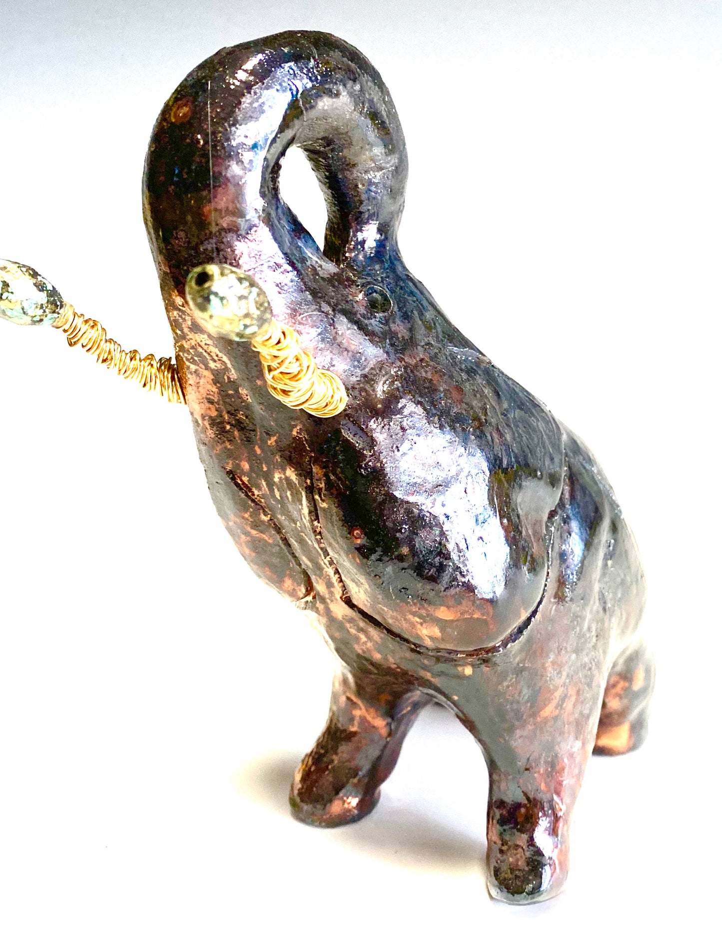Raku Elephant Have you HERD!!!!!! Just one of these lovely Raku Fired Elephant will make an excellent gift for your friend, sorority or for your home’ special place centerpiece. 6" x 4" x 3" 13 ozs. Beautiful dark copper metallic raku elephant For decorative purposely only.