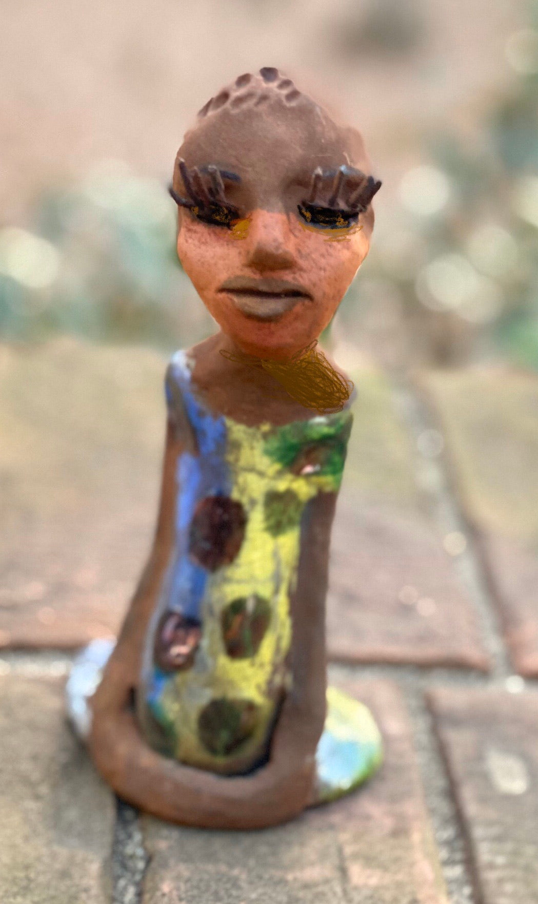 Adisa stands 7' x 4"x 2" and weighs 10.3 ozs. She has bright dark eyes and a nice honey two tone brown complexion Her long trademark arms rest at her side. Adisa dress is a loving glossy blue and yellow mix with copper flashes.