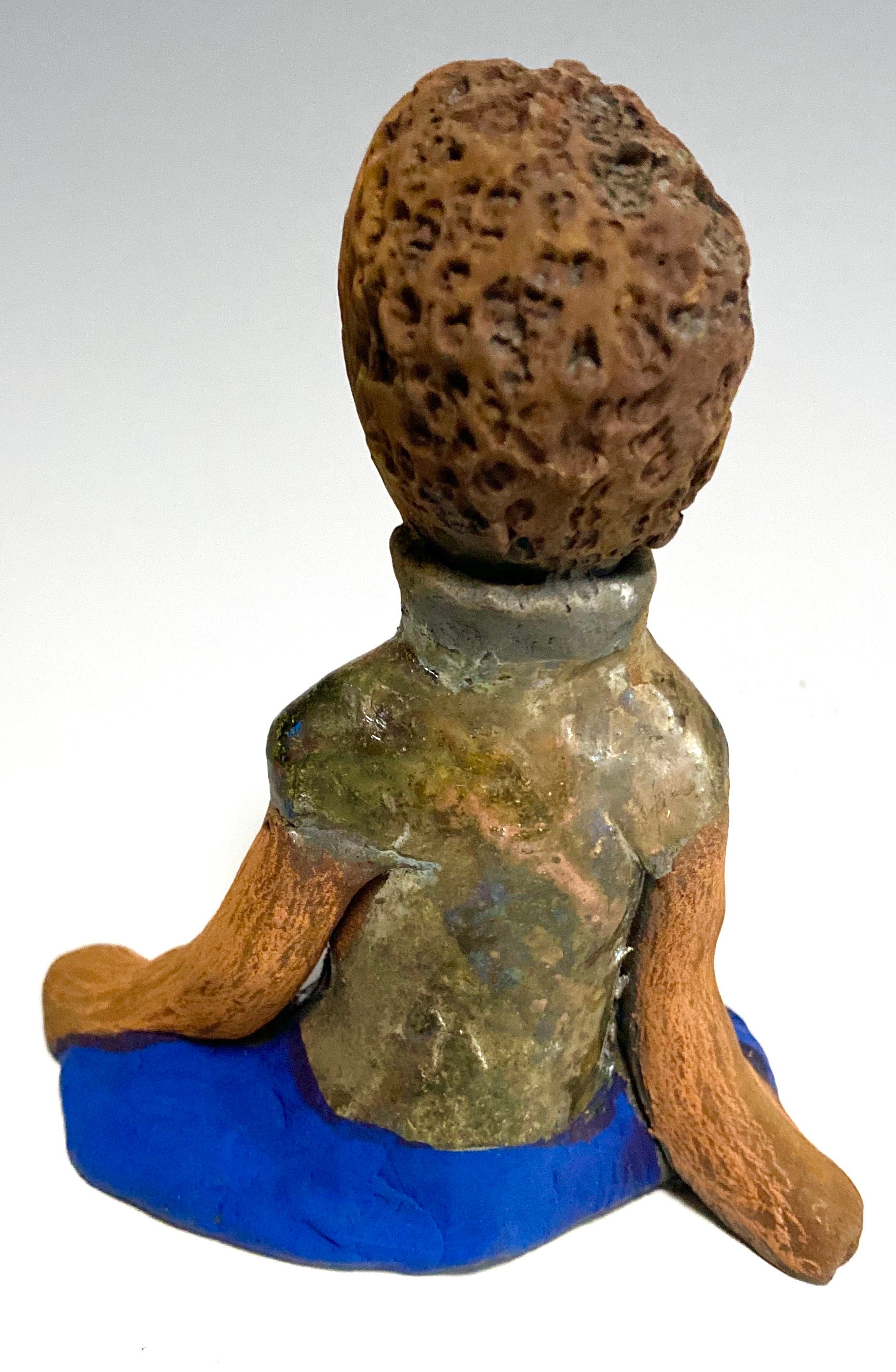 Travis is one teen who does respect his elders.   Travis stands  5" x 4" x 3" and weighs 9 ozs. He wears a metallic green shirt with blue jeans . Travis complexion is honey brown. He is thoughtful with a gentle spirit His  arms rest at his knees as he waits on you.