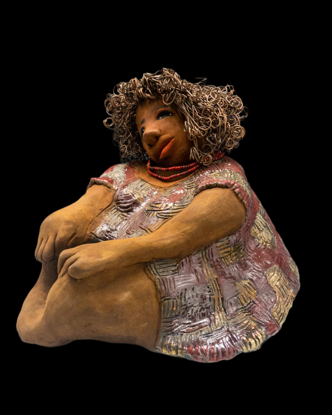Introducing Rose! You'll be captivated by her irresistible charm! She's a curvy gal with a "herdew" hairstyle that I added some color to. Her honey rust complexion is absolutely lovely and she enhances it with rose-colored eye shadow. Her dress features bold red and gold geometric patterns and is textured for a unique touch. Rose's long arms are gently folded on her lap. Her hair is made of curly 16 gauge black wire and was carefully styled for a playful look. Measuring approximately 11" x 13" x 13" and wei