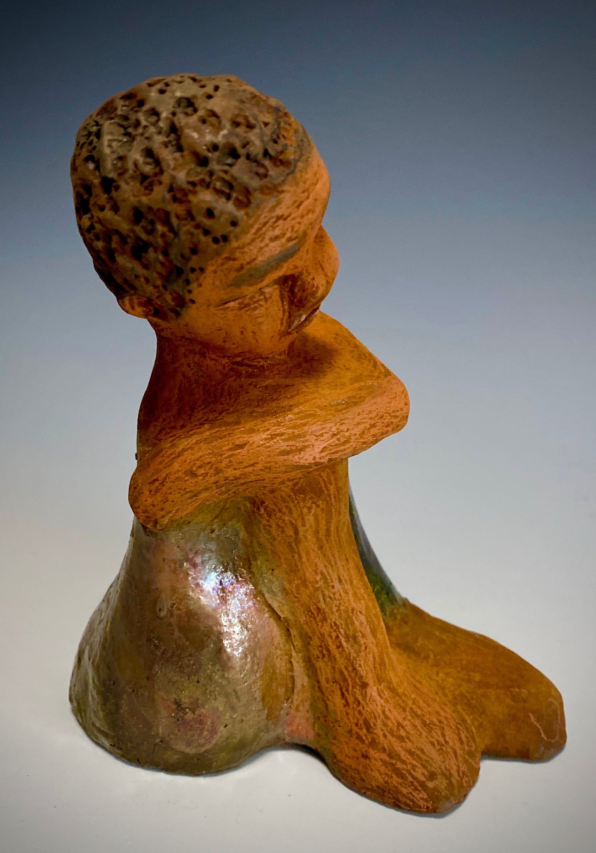Carlos is one teen who will think before he reacts!   Carlos stands  6.5" x 4" x 5" and weighs 1.7 lbs. He wears a matching metallic green shirt and jeans . Carlos complexion is honey brown. He is thoughtful with a gentle spirit His  arms  are wrapped around  his knees as he waits on you.