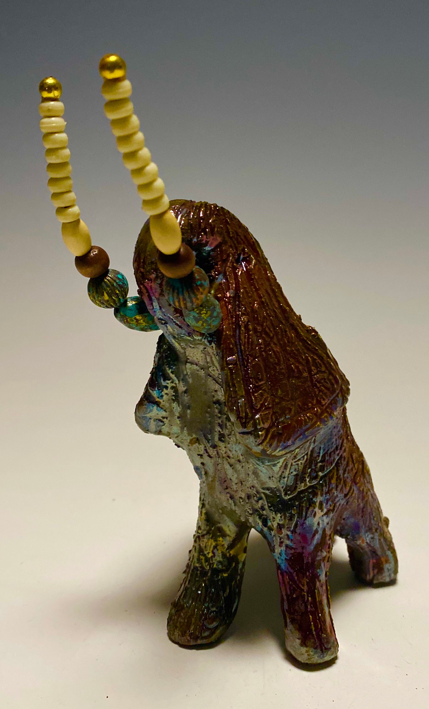 Raku Elephant Have you HERD!!!!!! Just one of these lovely Raku Fired Elephant will make an excellent gift for your friend, sorority or for your home’ special place centerpiece. 6" x 4" x 4" 1.7 lbs Beautiful copper metallic baby raku elephant Beaded white tusk. For decorative purposely only. Great Gift!