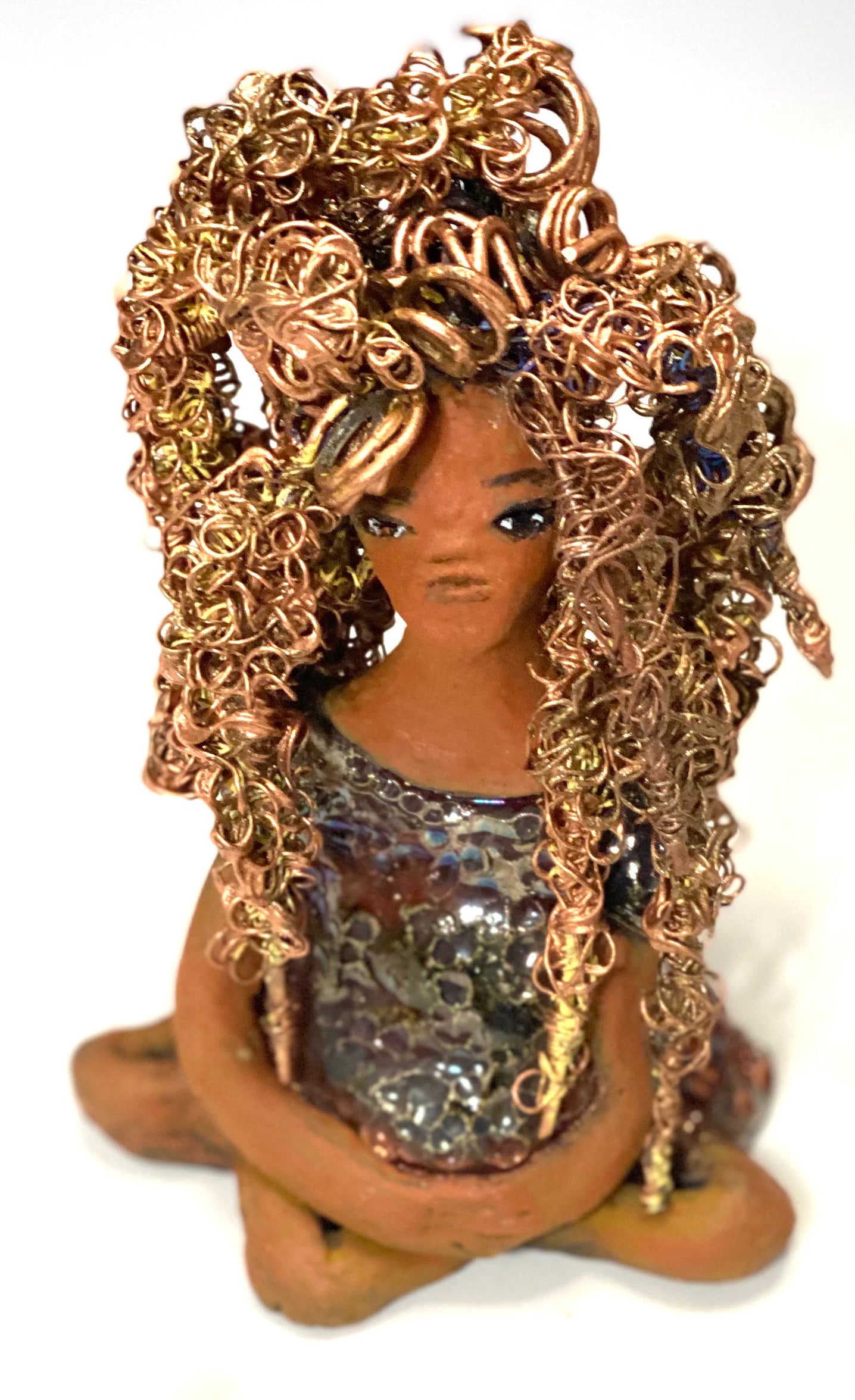 Meet Tiana! Tiana stands 5" x 3.5" x 3.5" and weighs 10 ozs. She has a lovely honey brown complexion. Tiana's dress is metallic copper. She has her long loving arms resting at her side. " I am really pleased with Tiana's blue beaded necklace and her new wire hair Find a place in your space for Tiana!
