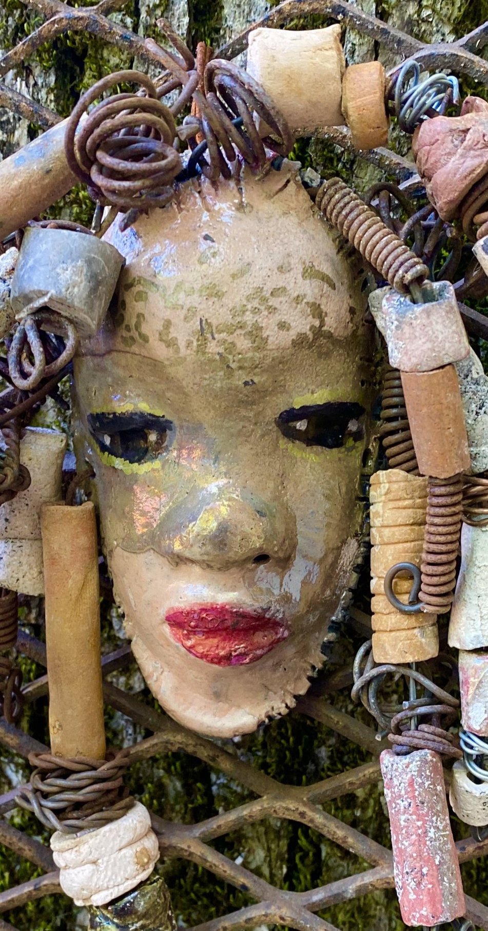 I started making art soon after seeing authentic African artwork at the Smithsonian Museum of African Art. I was in total awe. Brenanna was inspired by my visit there. Brenanna has a two tone copper gold complexion. She is 9" x 9" and weighs 1 lbs. Brenanna has over 25 handmade raku fired beads. Brenanna has over 15 feet of coiled 16 gauge wire hair.