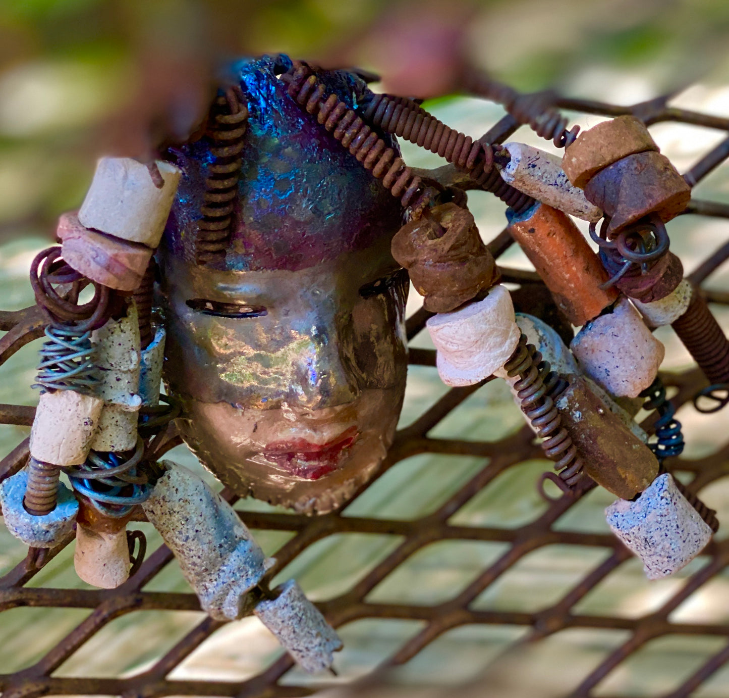 I started making art soon after seeing authentic African artwork at the Smithsonian Museum of African Art. I was in total awe. Jerri was inspired by my visit there. Jerri has a two tone copper gold complexion. She is 8" x 5" and weighs 11 ozs. Jerri has over 20 handmade raku fired beads. Jerri has over 10 feet of copper coiled 16 gauge wire hair.