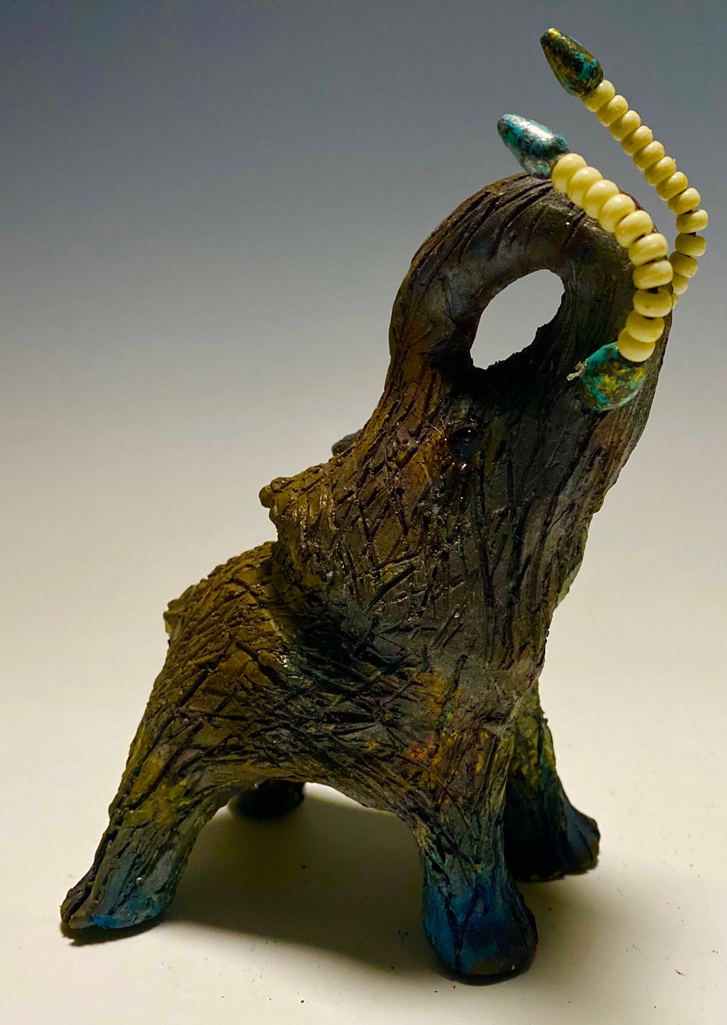 Have you HERD!!!!!! Elephants are one of my favorite animals to create. They are so majestic" Just one of these lovely Raku Fired Elephant will make an excellent gift for your BFF, or just for you . This raku fired elephant stands 6" x 4" x 5" and weighs 1 lb. She has beaded tusks and a textured charcoal and copper metallic body. This one is nice to add your Herdew Collection!