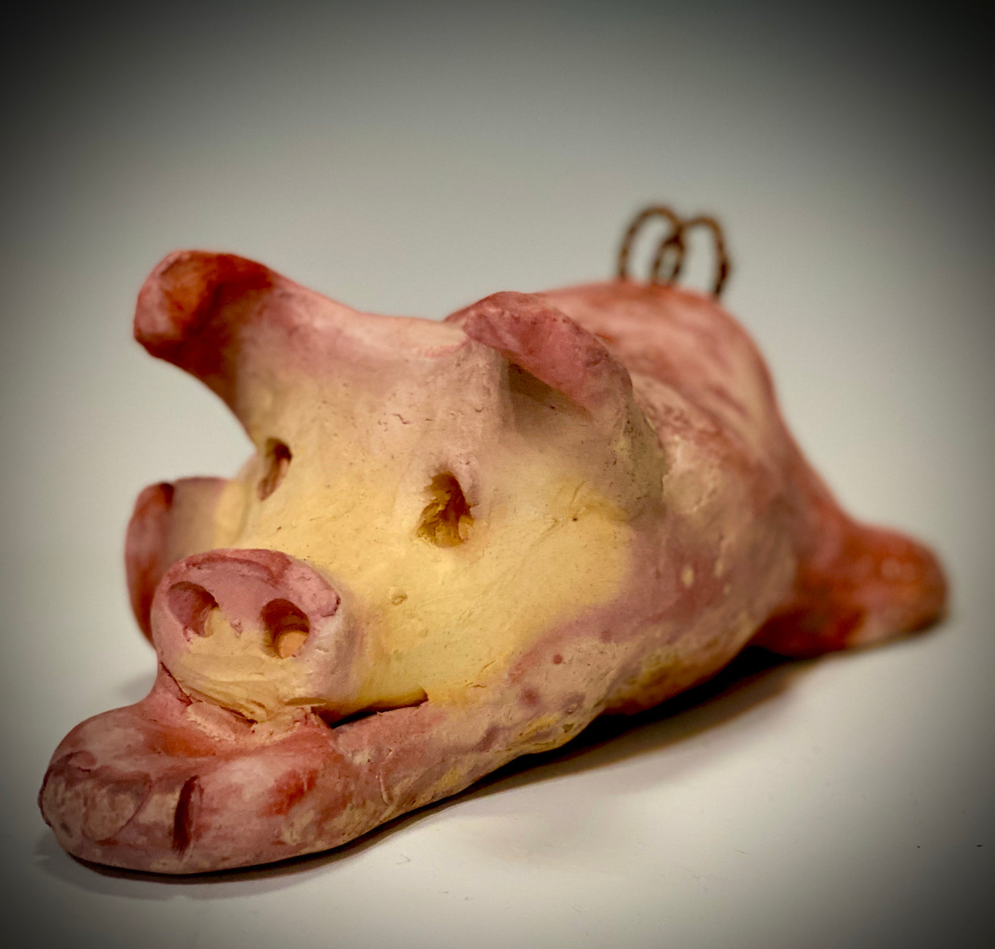 This Little Piggy named Olivia is approx. 4" x 5' x 6" and weighs 1.8 lbs. Olivia has a matte and satin pinkish complexion. Olivia little curly tail is made of wire.