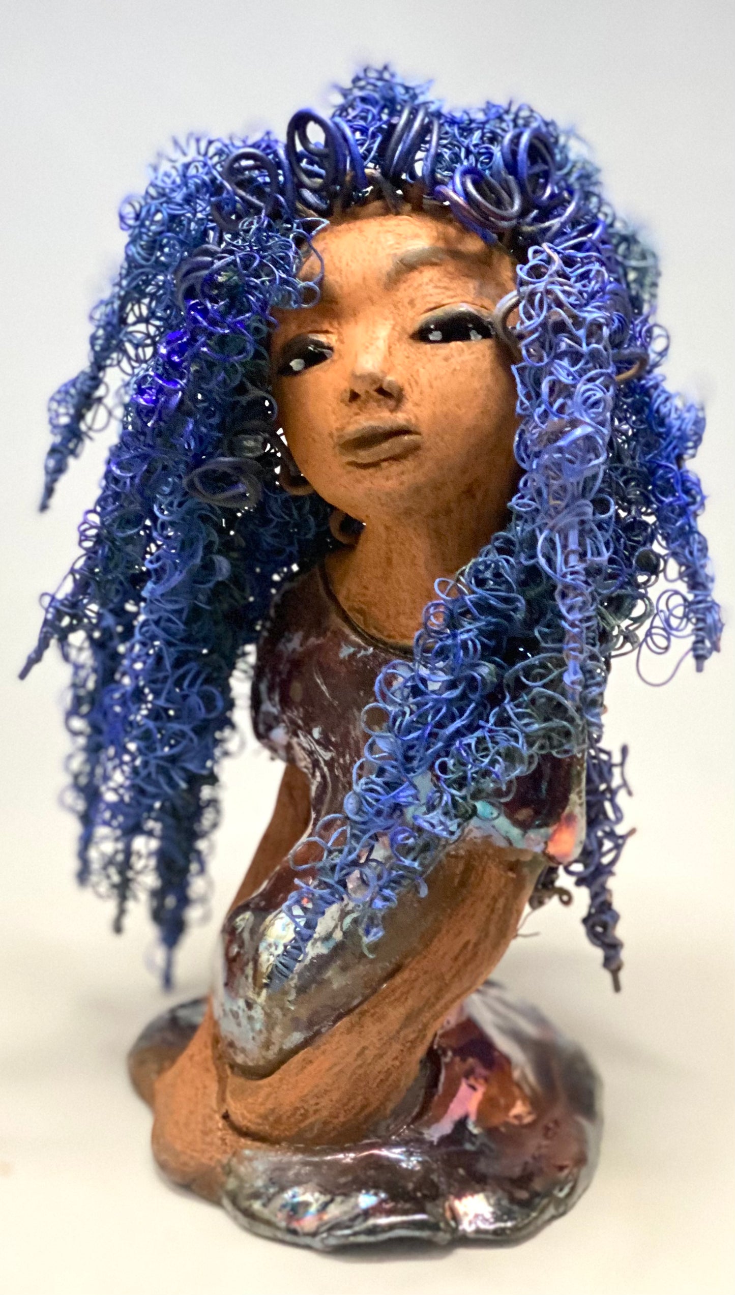 Rachel Rachel stands 8" x 6" x 5.5" and weighs 1.9 lbs. She has a lovely honey brown complexion with cocoa brown lips. She has long twisted wire locs hairstyle waist down! Rachel has a very colorful metallic copper blue antique glazed dress. She has over 75 feet of 16 and 24 gauge wire for hair. It took over 6 hours just to do her hair! With eyes wide opened, Rachel has hope of finding a new home.