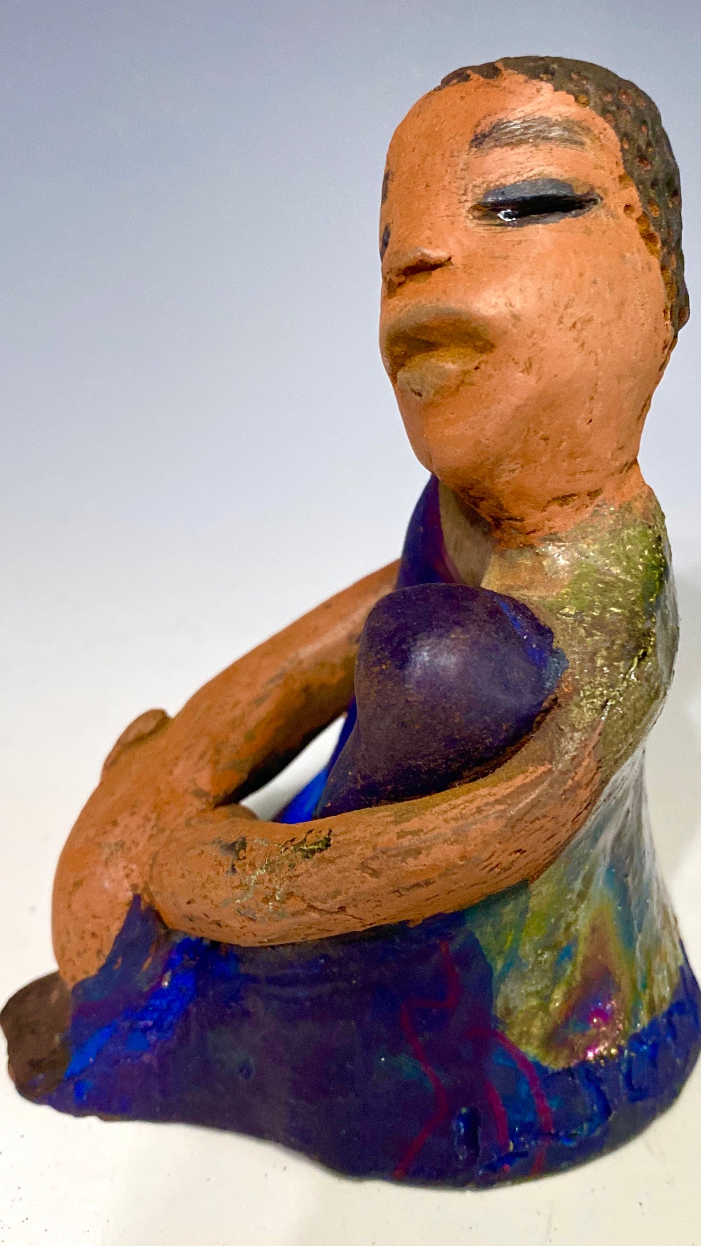 Paul is a Handsome Mischief Guy! Do you see the wit in his face? Paul stands 4.5"x 3" x 3" and weighs 6.9 ozs. He has a shimmery metallic tee shirt. Paul's complexion is honey brown. His arms are folded around his legs as he ponders another mischief moment!