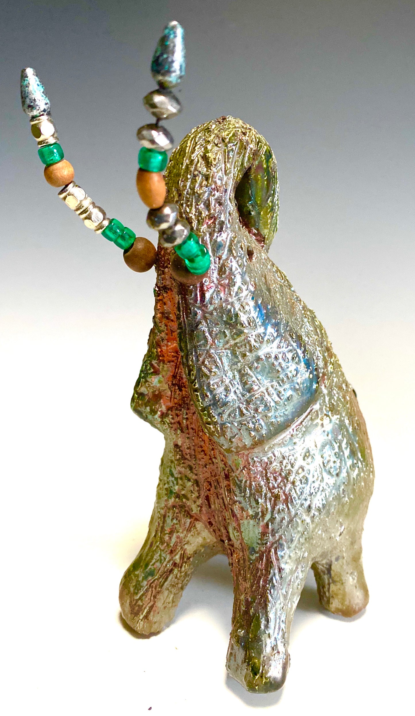 Raku Elephant Have you HERD!!!!!! Just one of these lovely Raku Fired Elephant will make an excellent gift for your friend, sorority or for your home’ special place centerpiece. 7.5" x 4" x 7" 1.10 lbs Multi beaded tusk Beautiful metallic copper gold raku glazes For decorative purposely only.