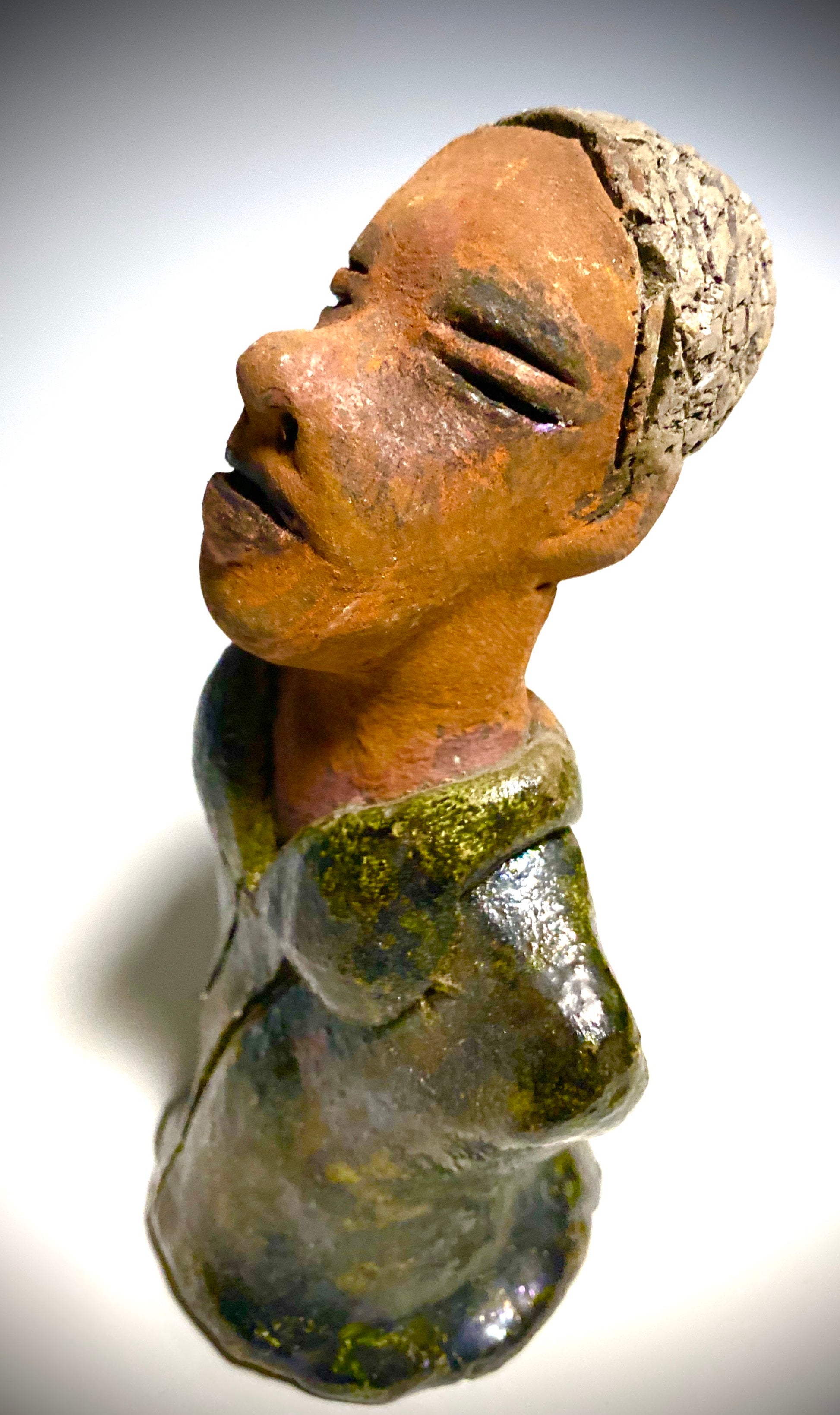 Mr. Charles has a story to tell!  Do you See the wisdom in his face? Mr. Charles  stands 5"x 3" x 2.5" and weighs 11 ozs. He wears a copper green metallic jacket. Mr. Charles's complexion is honey brown and he has salt and pepper hair.