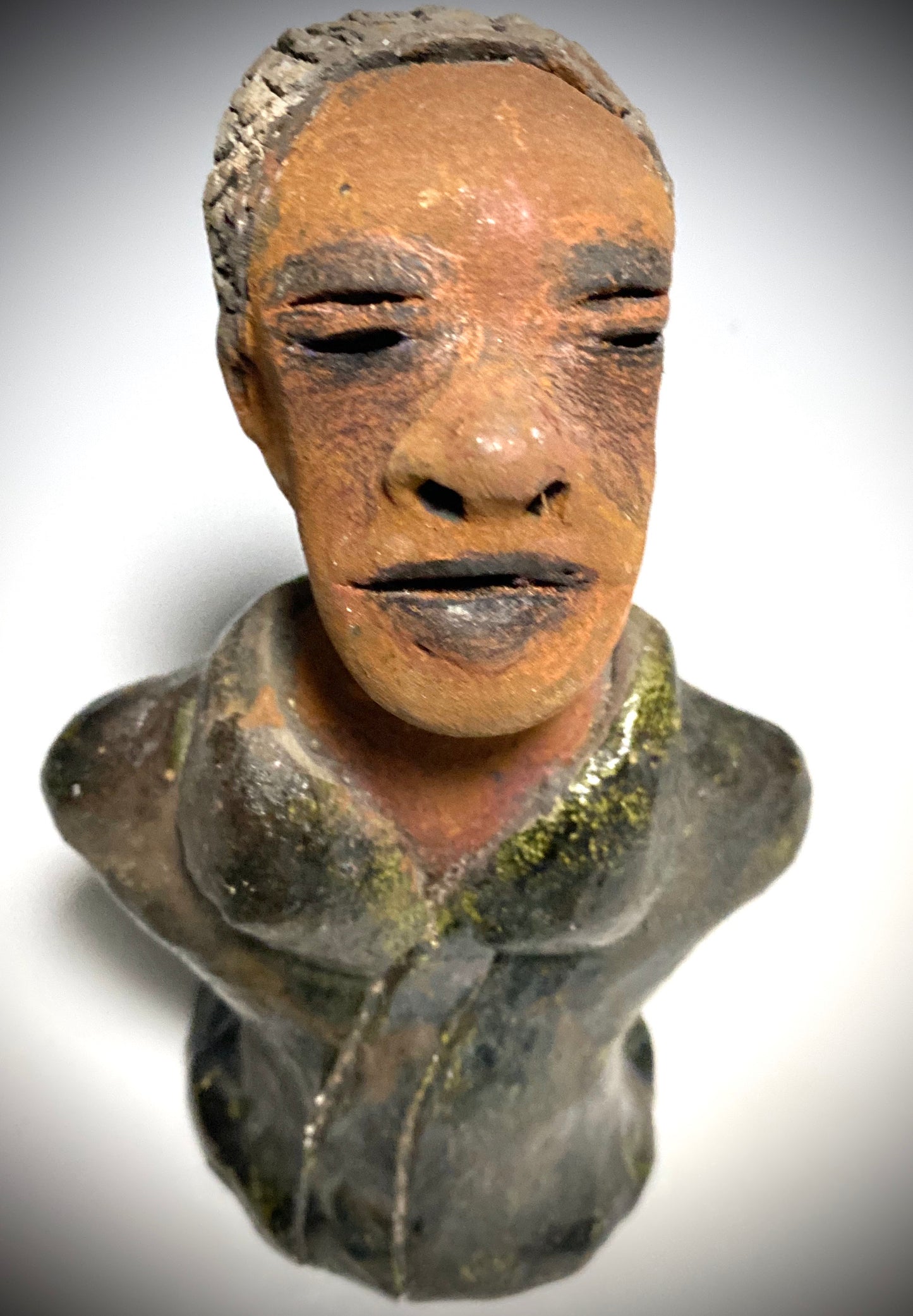 Mr. Charles has a story to tell! Do you See the wisdom in his face? Mr. Charles stands 5"x 3" x 2.5" and weighs 11 ozs. He wears a copper green metallic jacket. Mr. Charles's complexion is honey brown and he has salt and pepper hair.