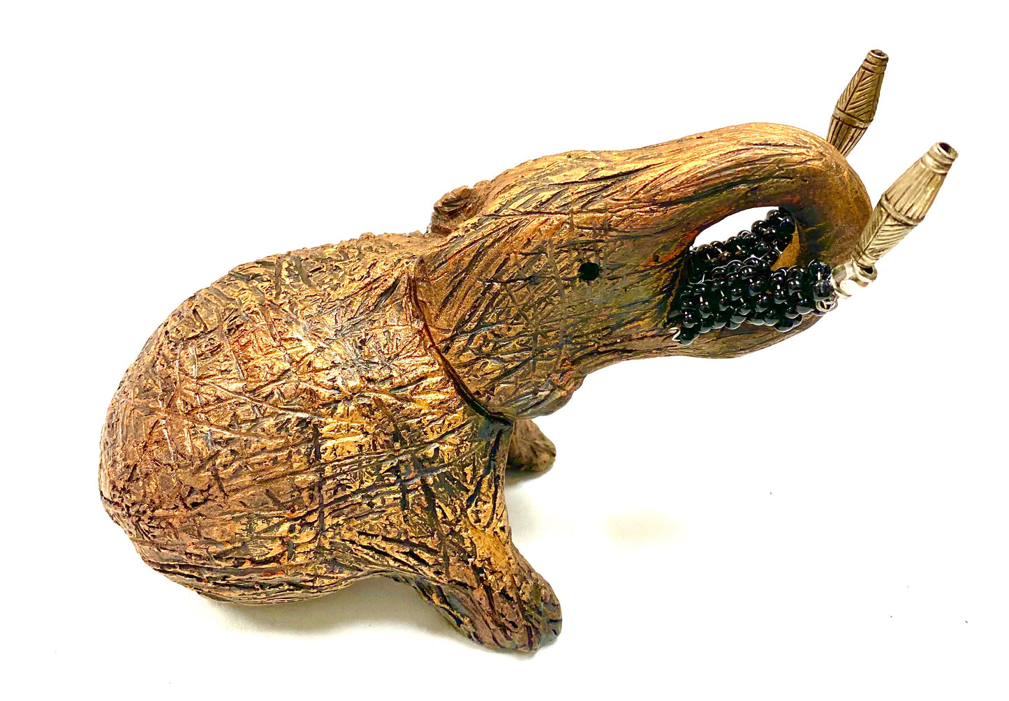 Have you HERD!!!!!! Elephants are one of my favorite animals to create. They are so majestic" Just one of these lovely Raku Fired Elephant will make an excellent gift for your BFF, or just for you . This raku fired elephant stands 5" x 4" x 7" and weighs 1 lb. She has black beaded tusks and a textured and copper metallic body. This one is nice to add your Herdew Collection!