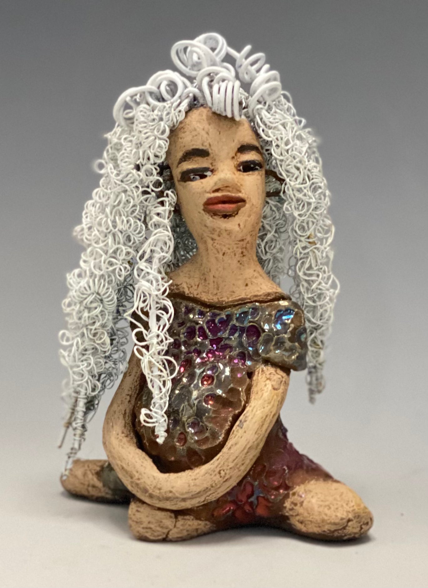 Alyssa stands 6" x 5" x 5" and weighs 12 ozs. She has a lovely honey brown complexion with cocoa brown lips. She has long twisted white wire locs hairstyle waist down! Alyssa has a metallic copper antique glazed dress. She has over 75 feet of 16 and 24 gauge white wire for hair. It took over 3 hours just to do her hair! With eyes wide opened, Brianna has hope of finding a new home. You will love having Alyssa. She will attract and spark conversation with guest in your home!