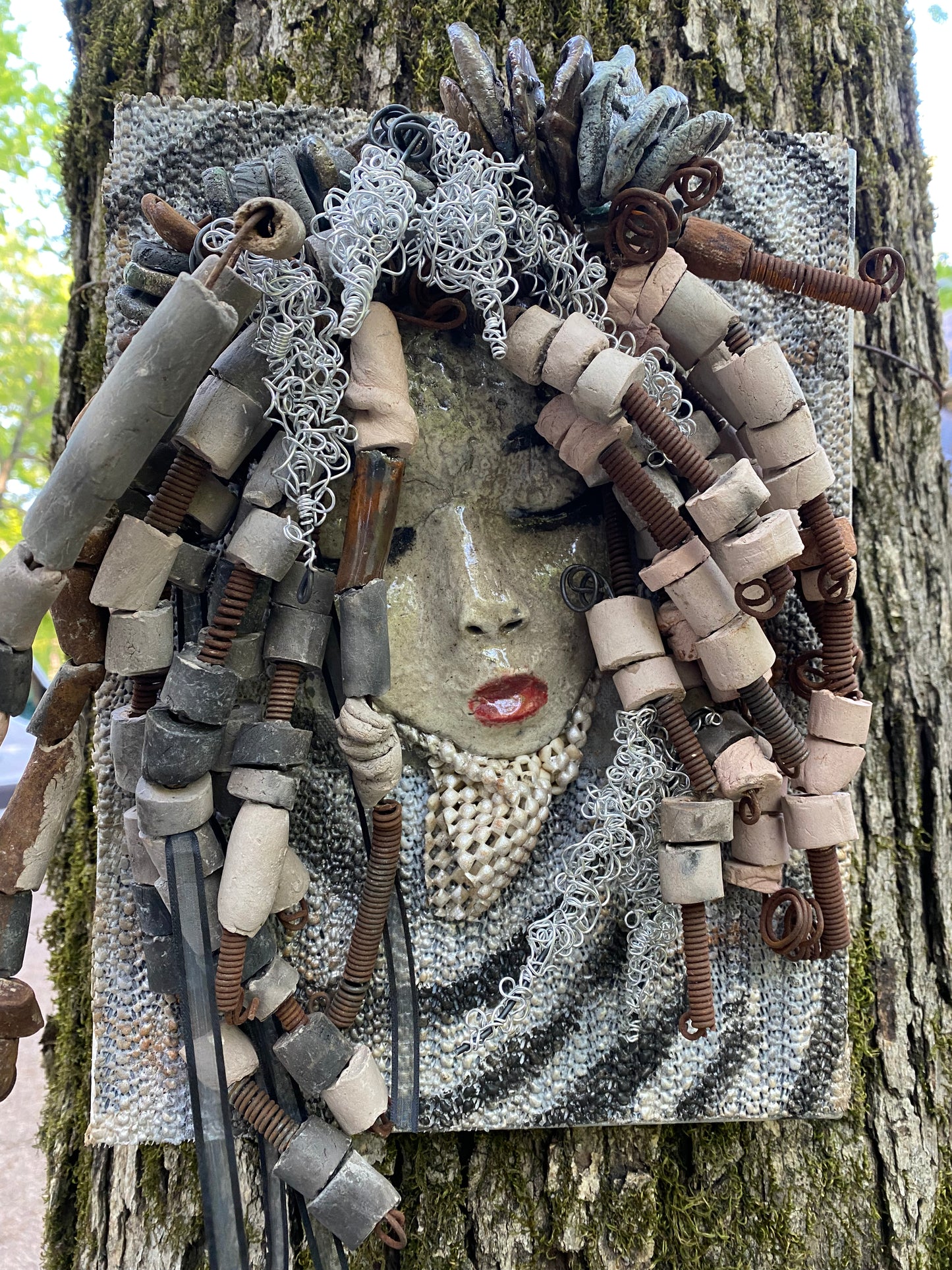 I started making art soon after seeing authentic African artwork at the Smithsonian Museum of African Art. I was in total awe. Sergio was inspired by my visit there. Sergio is mounted on a 8"x 10" painted canvas. I spent about 4 hours or more just fixing Sergio's hair and attaching beads! Sergio has over 40 feet of 16 gauge wire for hair and over 30 raku beads. Sergio has a white crackle face with ruby red lips. He weighs 2.10 lbs and is ready to be hung!