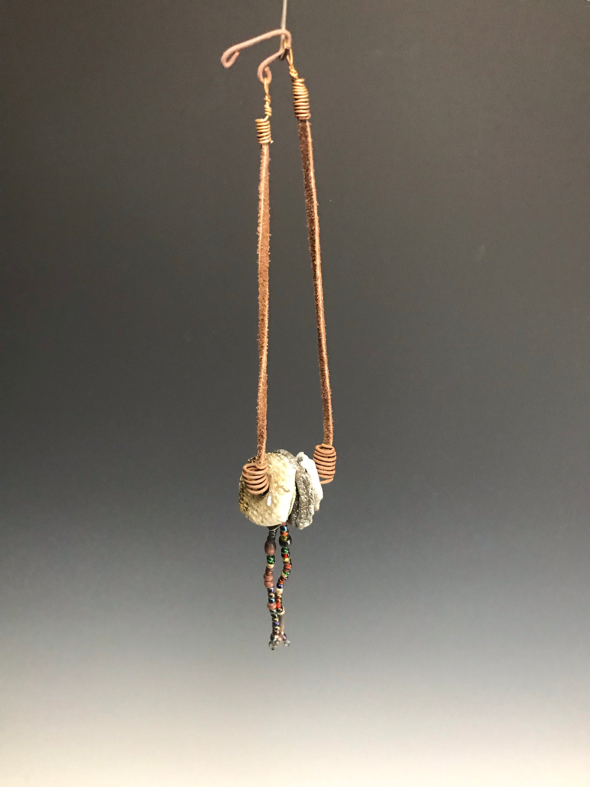 Simple and Beautiful!      14" cord     4 Raku fired discs     small acrylic beads     1.6 ozs     Nice!