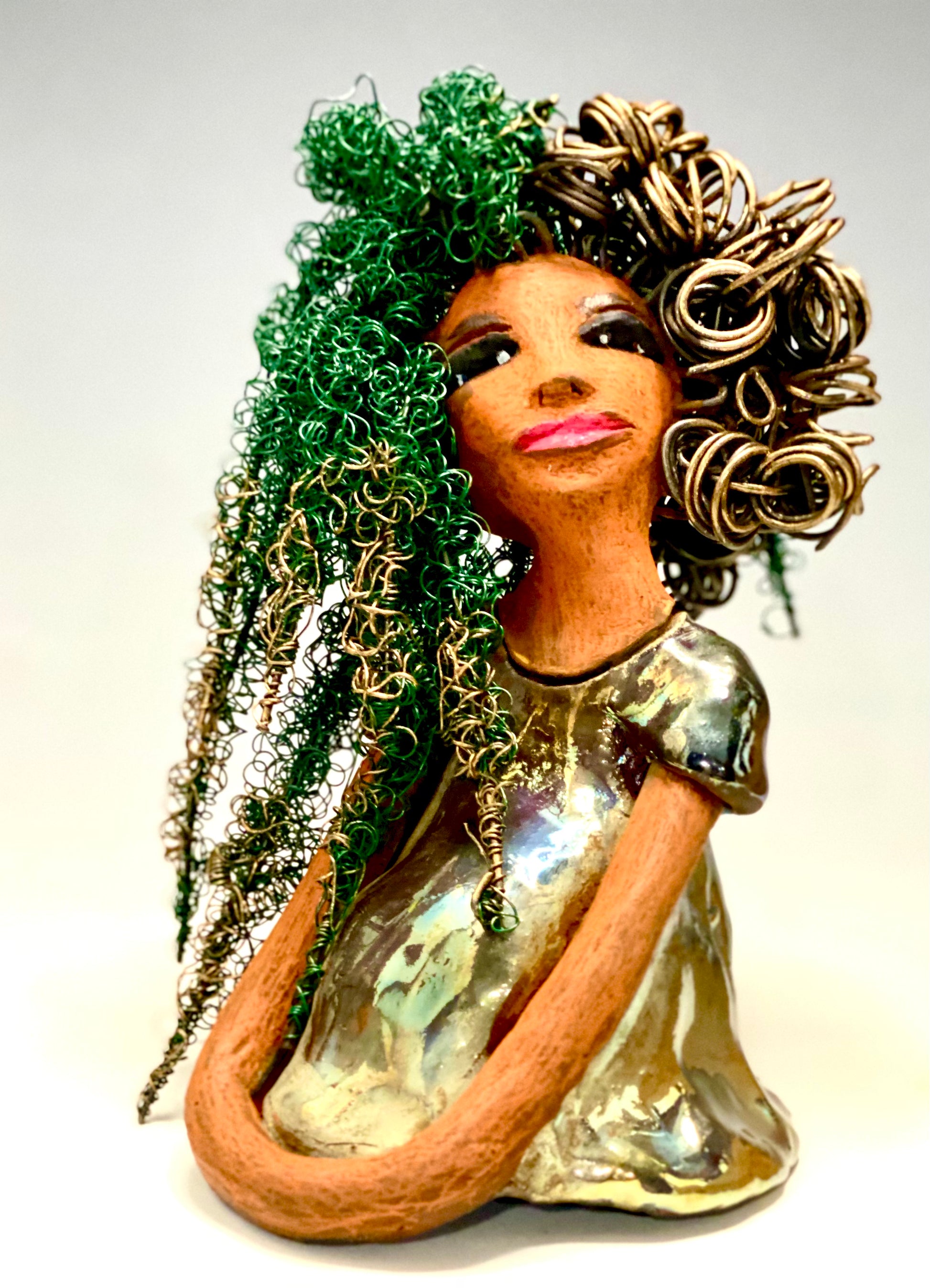 Diane stands 7" x 6" x 5.5" and weighs 1.9 lbs. She has a lovely honey brown complexion with reddish brown lips. She has long twisted wire locs hairstyle waist down!  Diane has a very colorful metallic  copper green antique glazed dress. She has over 75 feet of 16 and 24 gauge  wire for hair. It took over 6 hours just to do her hair! With  eyes wide opened, Diane has hope of finding a new home.