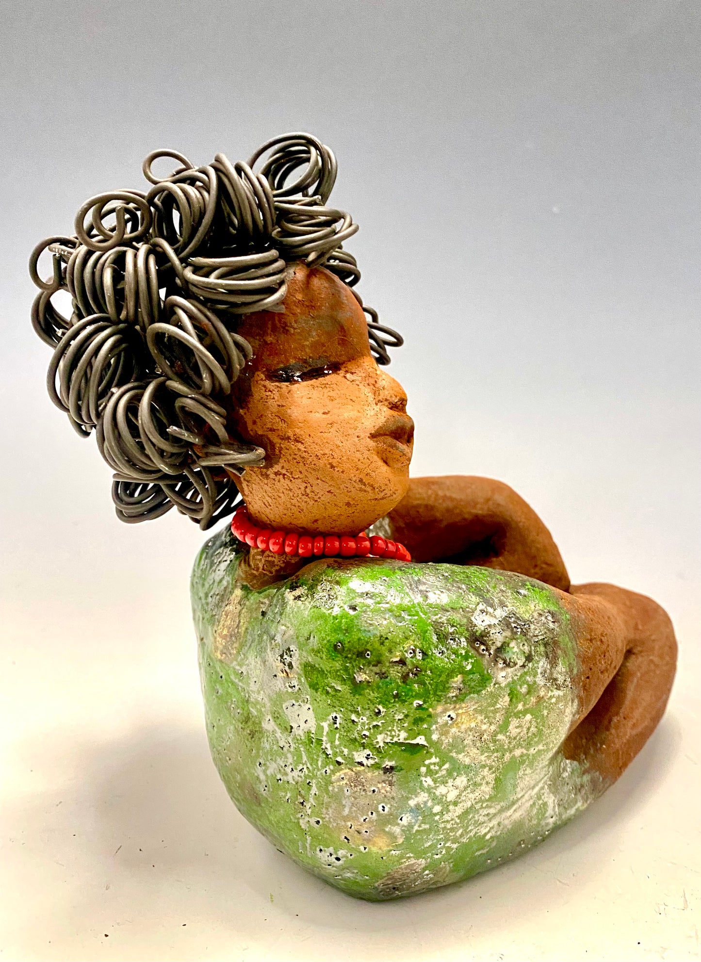 Meet Patricia! Patricia is approx. 6"x 4" x 5" and weighs approx. 1.5 pounds. Her long loving arms rest at her lap. Patricia has a lovely honey rust colored complexion. Yes she is a Big Girl! Patricia's dress is glossy green with large gold patterned dots . A string of ruby red beads wraps snugly around her neck. Patricia's hair is made of curly 16 gauge wire. Free Shipping! Got Questions???? Instant Message or Chat with me. Shipping and Returns