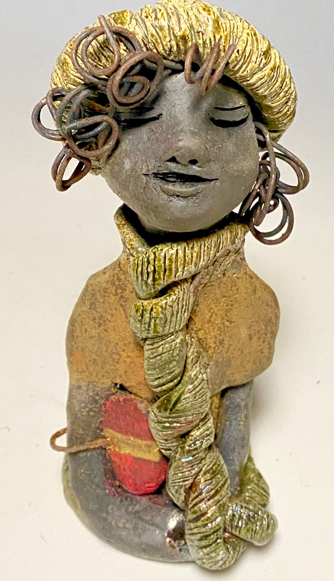 Meet Edna! Edna stands 6" x 3.5”x 4" and weighs 12.4 ozs. She has a dark lovely smokey black complexion. Edna has a glossy green and copper metallic dress. She clinches her designer Dark red purse. Edna wears a designer hat as well. With the current situation we All are going through, Edna will place a smile on your face during this challenging time. If not return Edna within 30 days after receiving her for a complete refund.