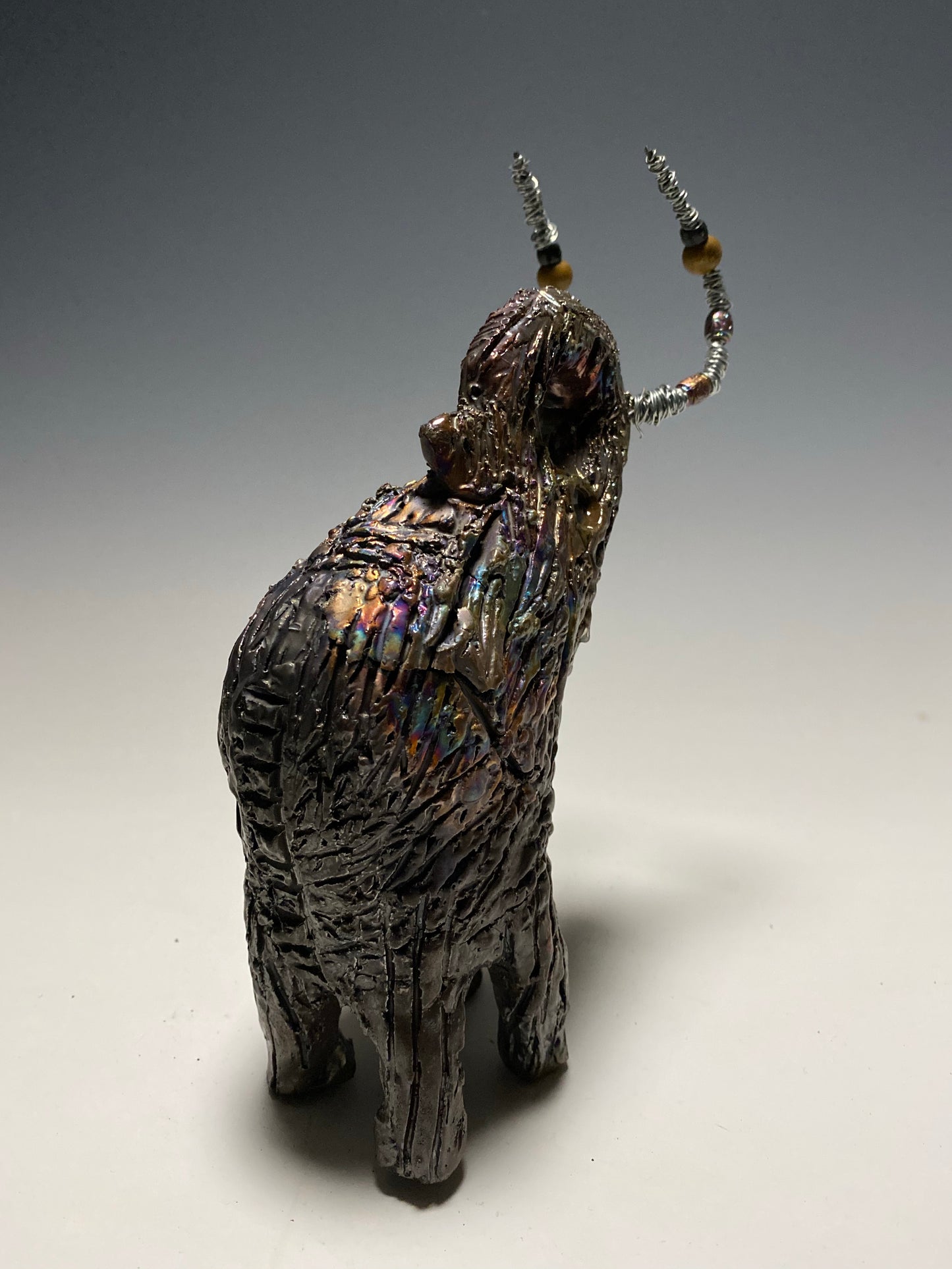 Raku Elephant Have you HERD!!!!!! Just one of these lovely Raku Fired Elephant will make an excellent gift for your friend, sorority or for your home’ special place centerpiece. 6" x 4" x 4" 1lbs Wood beaded with silver tusk Beautiful metallic raku colors For decorative purposely only.