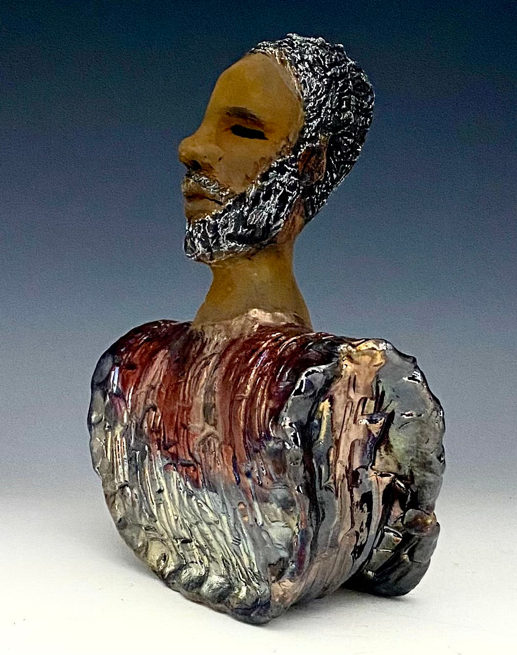 In Memory of April 4, 1968, Dr. Martin Luther King and the Civil Rights Movement. I Am a Man-2 is a declaration of civil rights, often used as a personal statement and as a declaration of independence against oppression. I am a Man stands 9" x 7" x 3.5" and weighs 2 lbs. I am a Man wears a colorful metallic blue and copper dashiki. He is bald and bearded. Yes ,,,,,,He is one of few Men found in the Herdew collection!