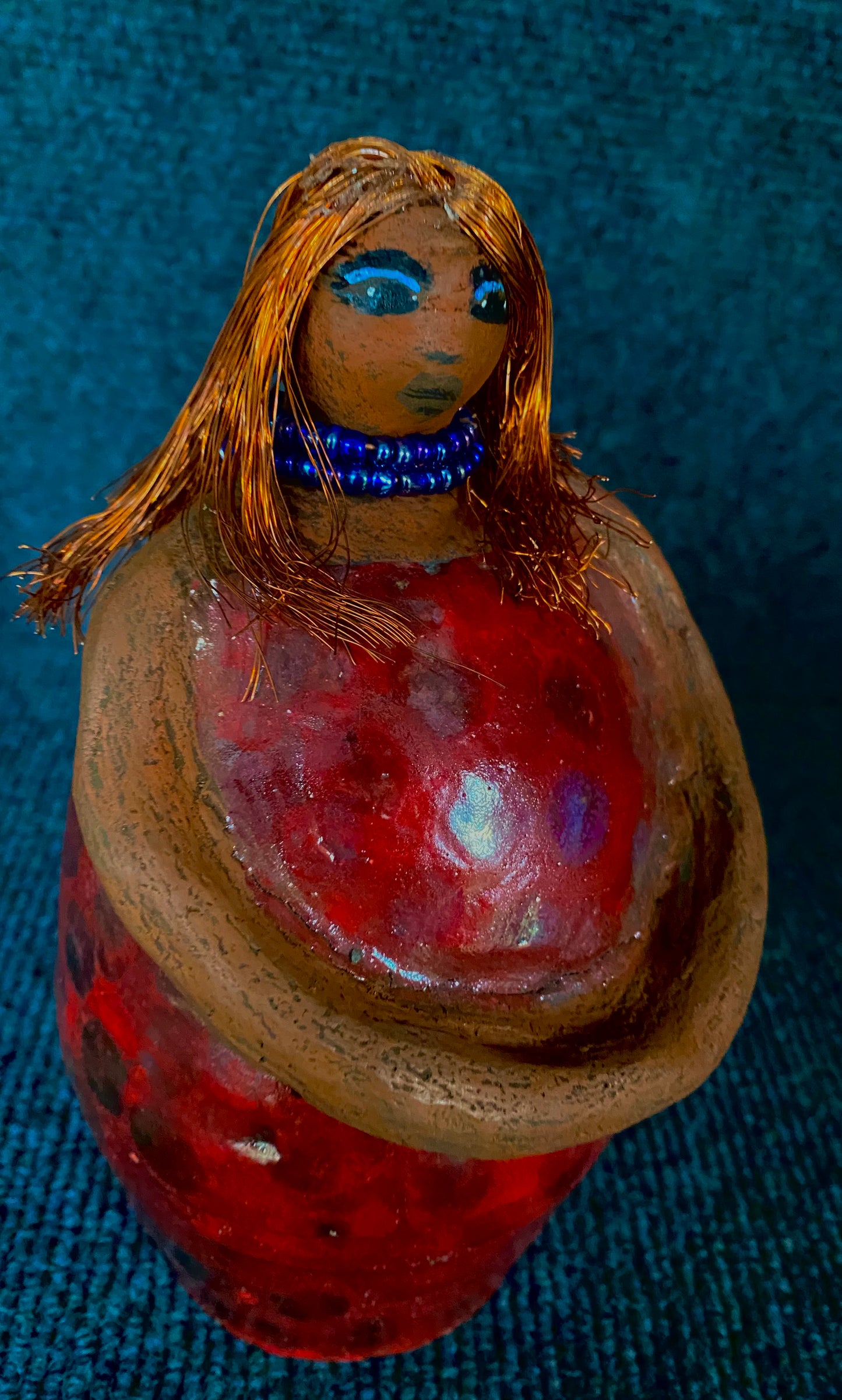 Meet Dora! She is a big girl who loves to sing and has aspirations of becoming a movie star. Dora stands 7" x 4" x 4.5" and weighs 1.06 lbs. She has a lovely honey brown complexion with lovely reddish brown lips. Dora has a lovely gold spotted heart glazed dress. She wears a beaded dark blue necklace. With eyes wide opened, Dora has hopes of finding a new home. Dora has a twin sister name Cora.