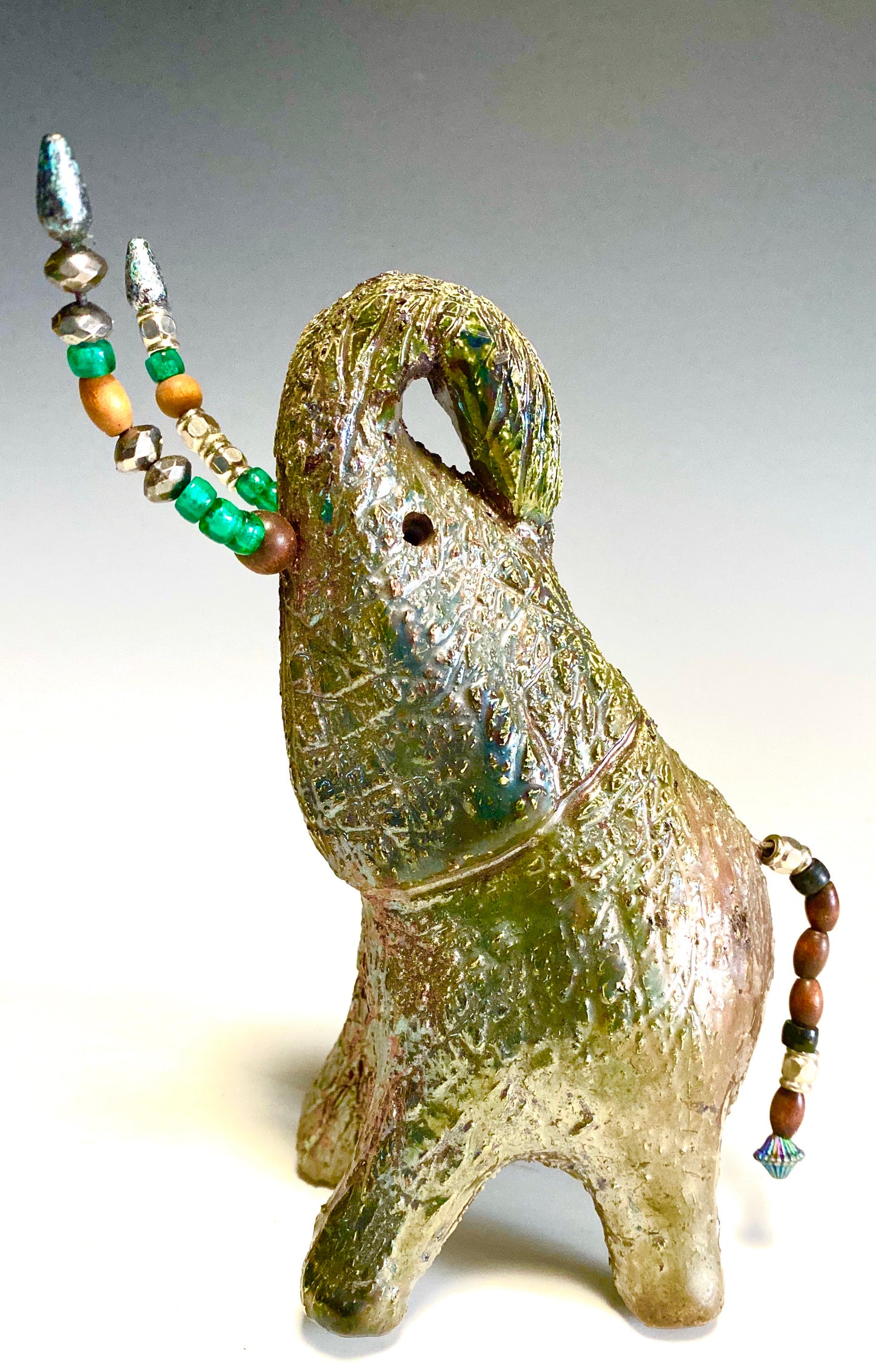 Raku Elephant Have you HERD!!!!!! Just one of these lovely Raku Fired Elephant will make an excellent gift for your friend, sorority or for your home’ special place centerpiece. 7.5" x 4" x 7" 1.10 lbs Multi beaded tusk Beautiful metallic copper gold raku glazes For decorative purposely only.