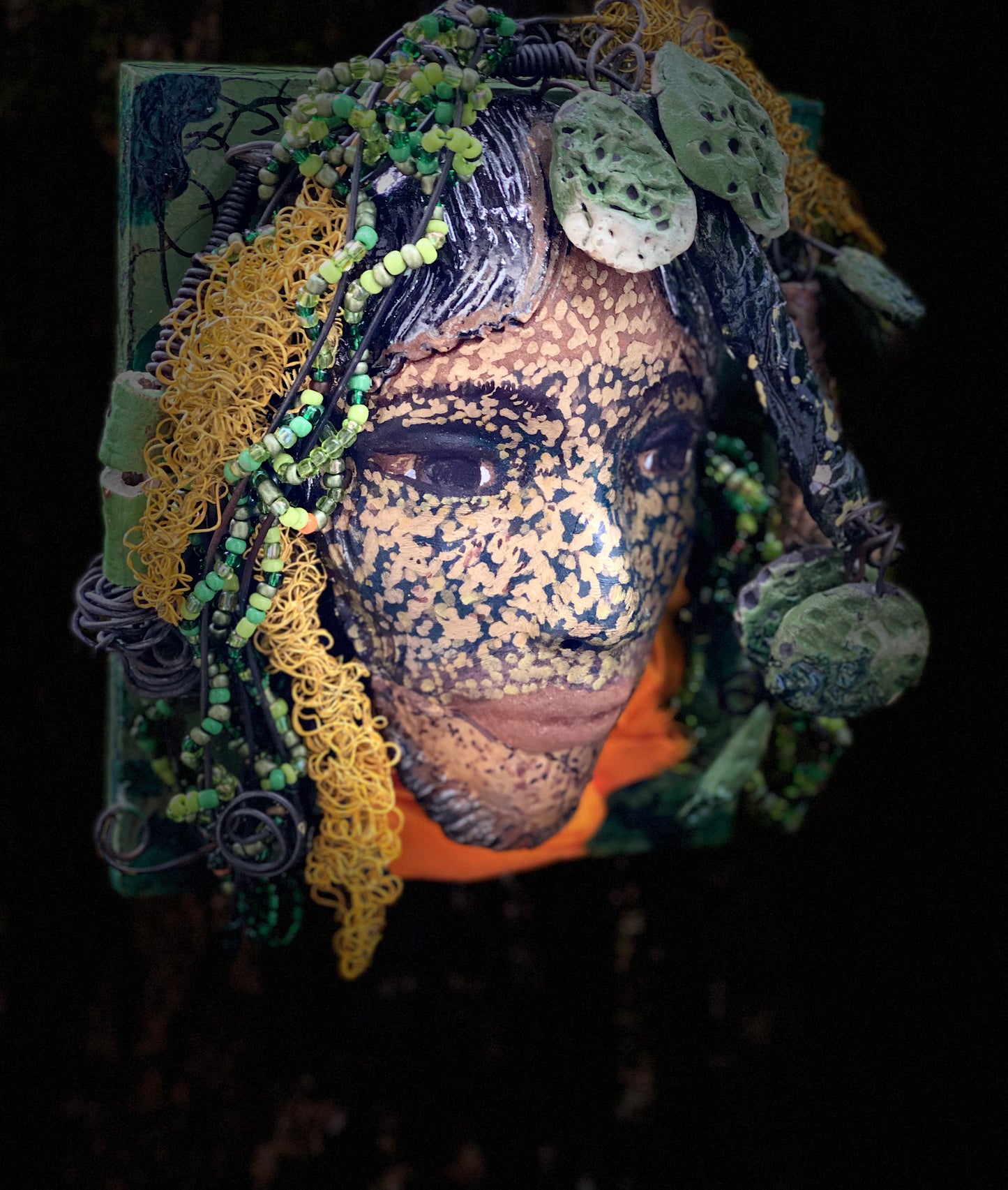 Casey is one of a new 2022 series of tribal masks that are mounted on wood. I started making art soon after seeing authentic African artwork at the Smithsonian Museum of African Art. I was in total awe. Casey is 6” x 7 x 1 and weighs 1.13 lbs. She has a contagious smile. Casey's face is speckled gold. 12 handmade raku fired beads Over 60 mini 6mm multi colored beads Over 60 feet of 16 and 24 gauge twisted wire for hair! Over two weeks to complete! Casey is ready to be mounted inside or outdoors!