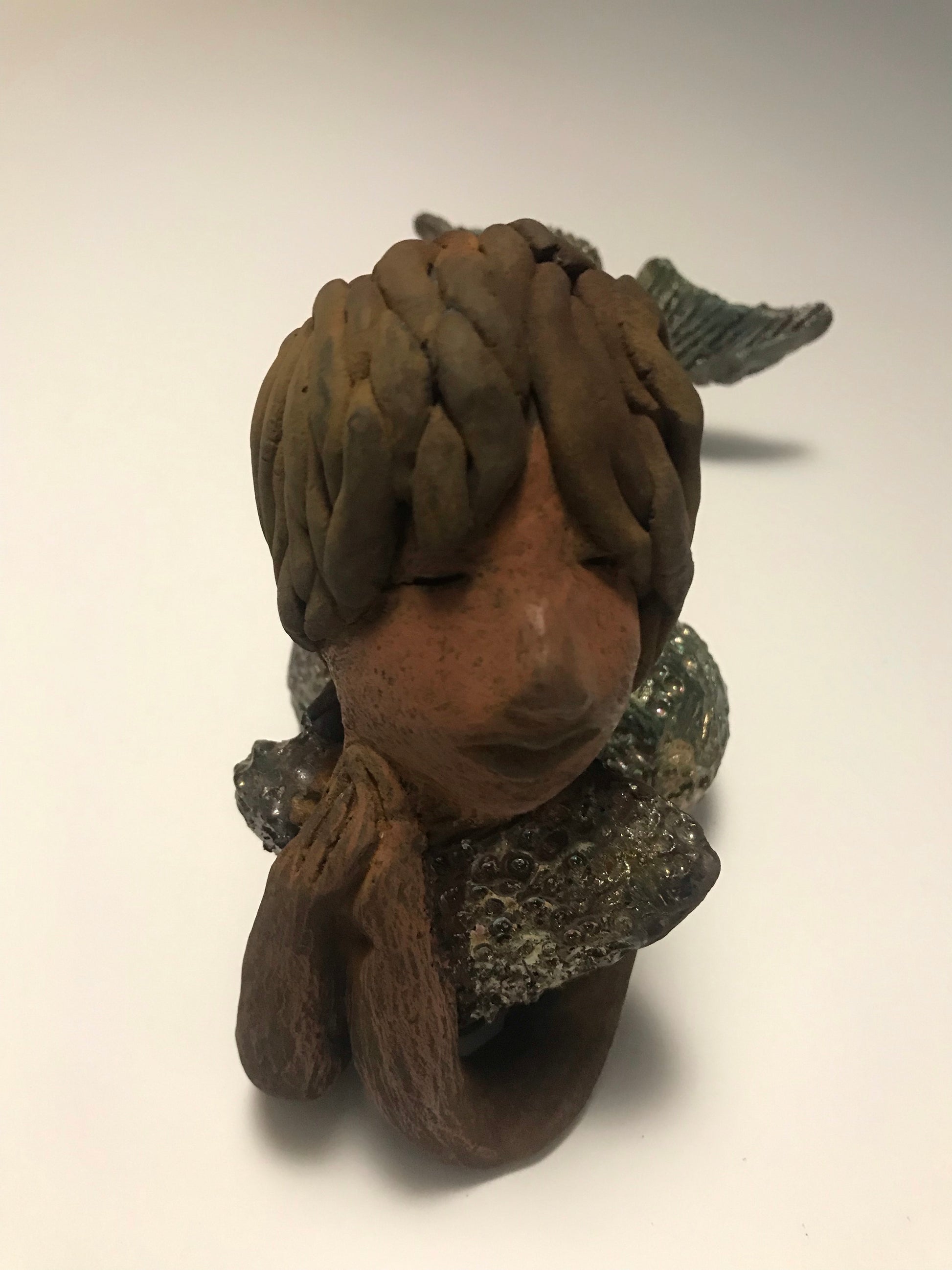 Meet Belinda!  Belinda is a voluptuous mermaid. She stands 6.5" X 5" 9.5" and weighs 2.04 lbs. Belinda has a dark chocolate complexion.      She wears a  dark smokey clay hairstyle.      She wears a glossy metallic swimsuit.     Belinda has a wide tail.     She will  definitely get somebody's attention.   Let Belinda get the conversation started at your home!
