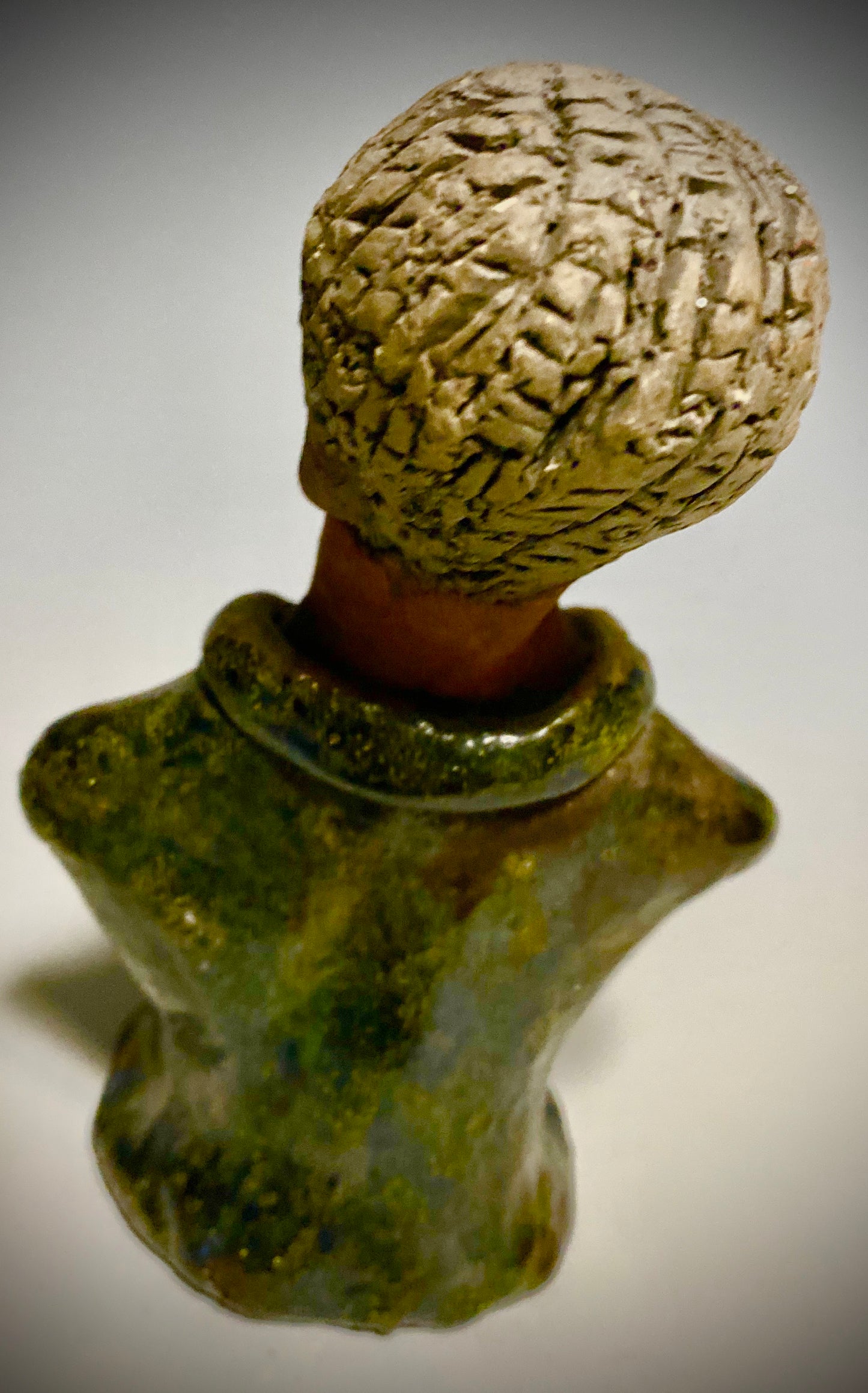 Mr. Charles has a story to tell! Do you See the wisdom in his face? Mr. Charles stands 5"x 3" x 2.5" and weighs 11 ozs. He wears a copper green metallic jacket. Mr. Charles's complexion is honey brown and he has salt and pepper hair.